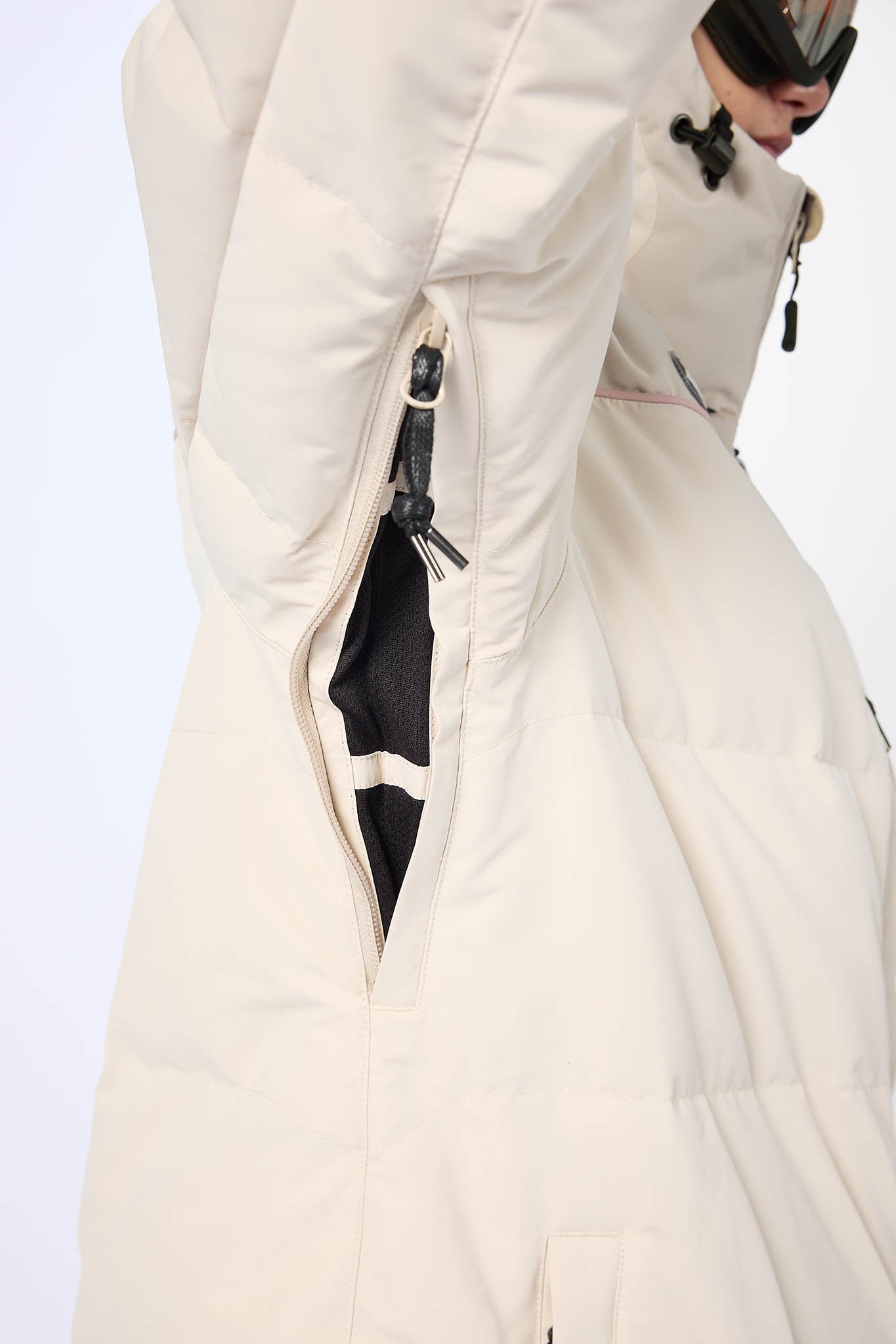 Close-up of a white winter coat with a hood on a light gray background