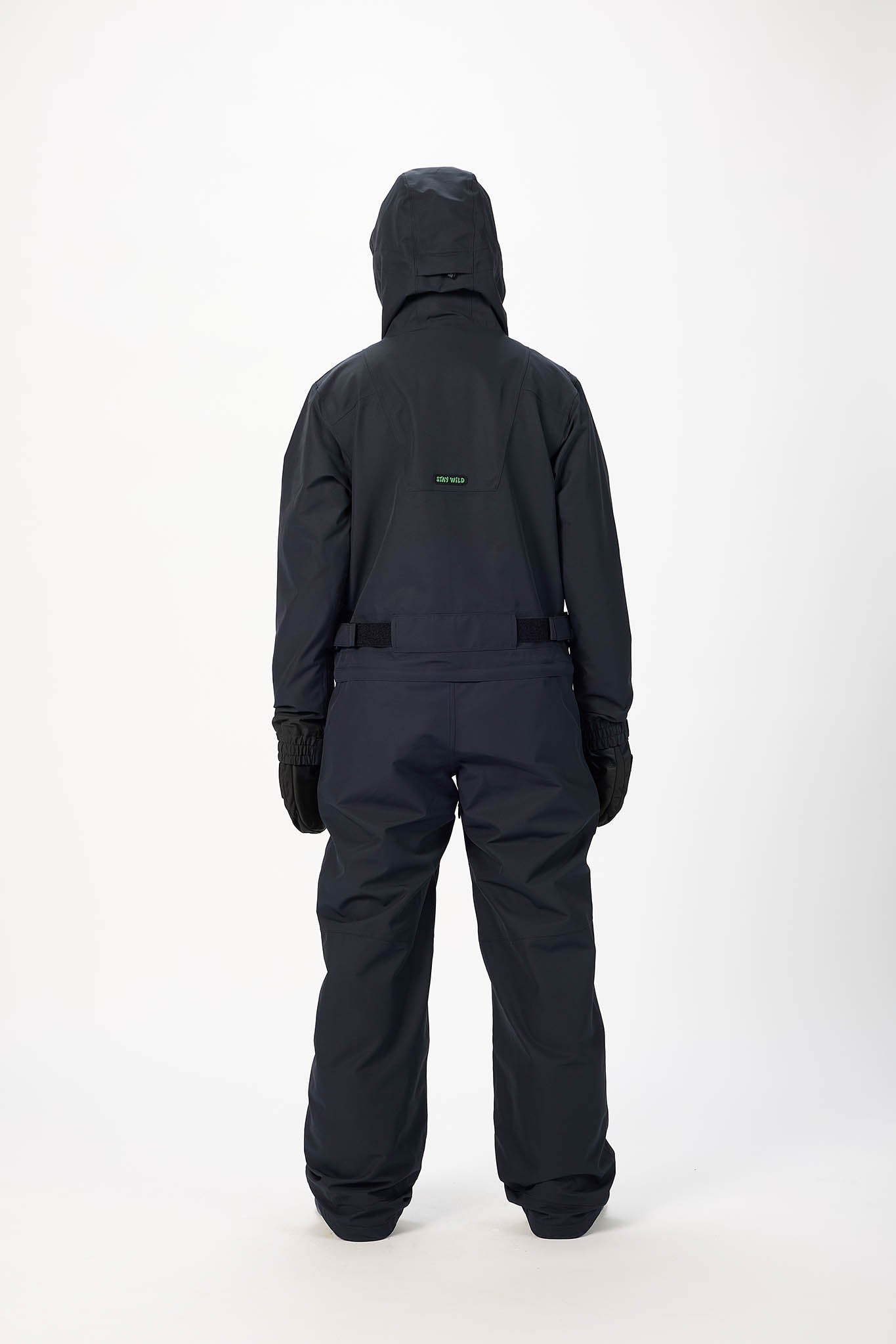 Person wearing a black snowsuit on a white background