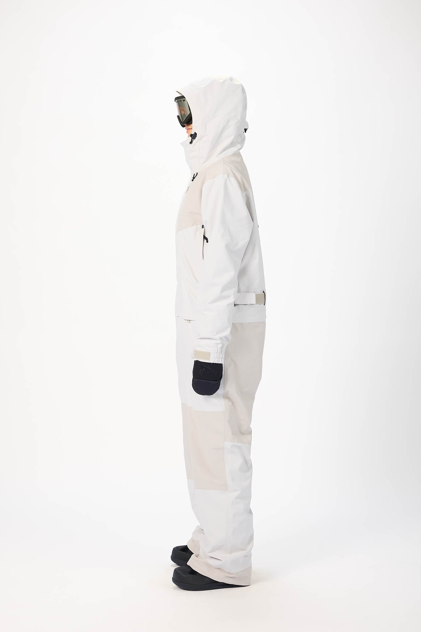 Person wearing a white snowsuit on a white background
