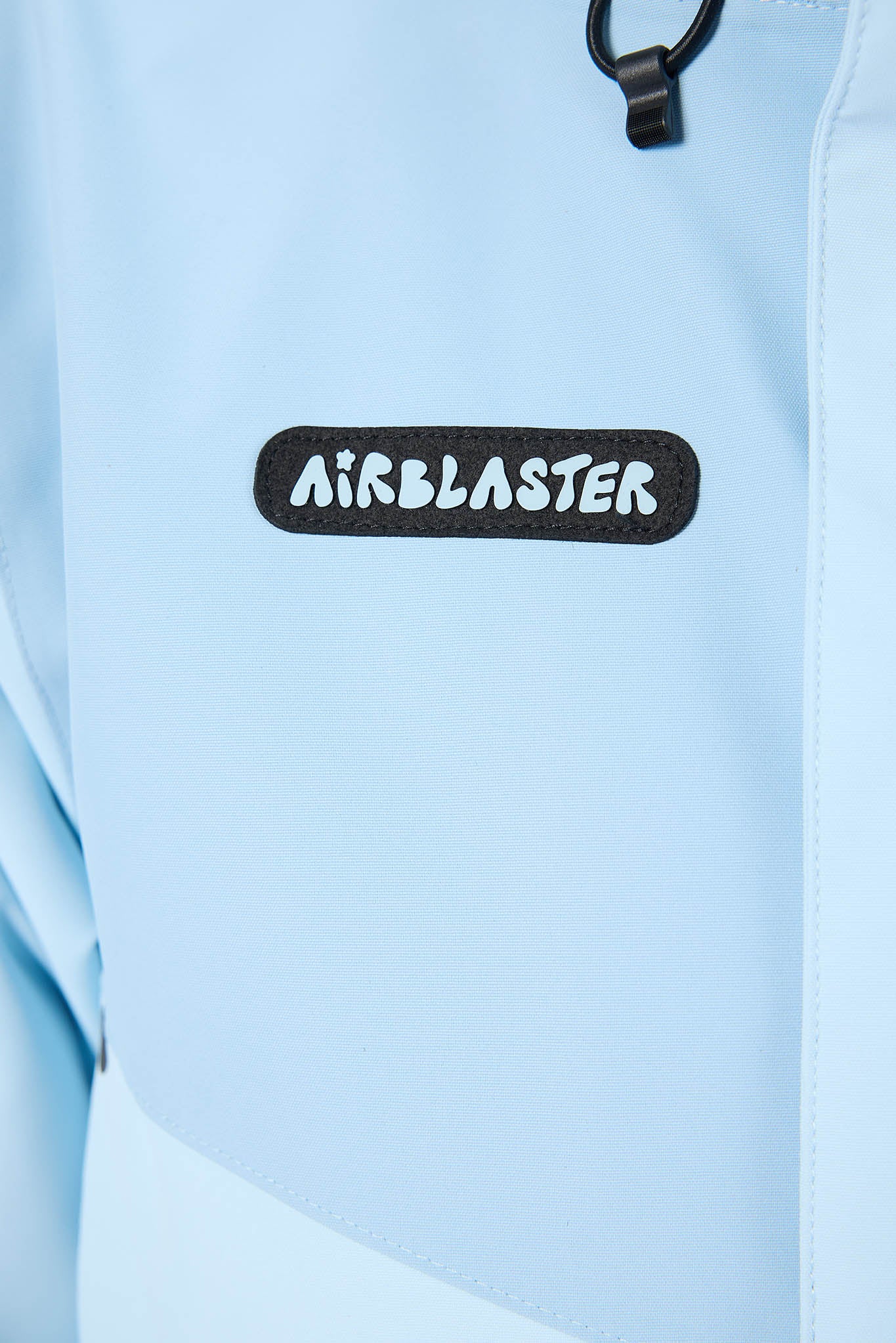 Light blue jacket with 'Airblaster' logo on a light blue background
