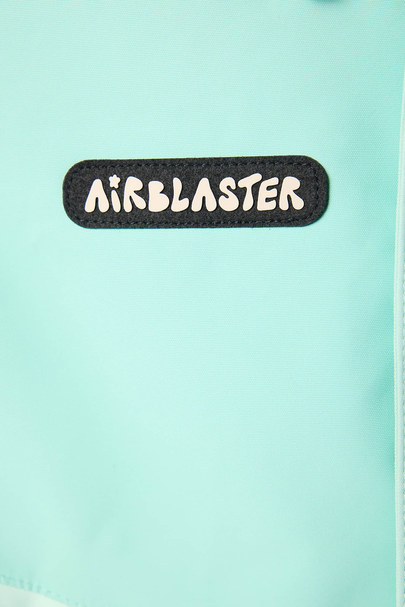 Close-up of 'Airblaster' logo on a light blue background