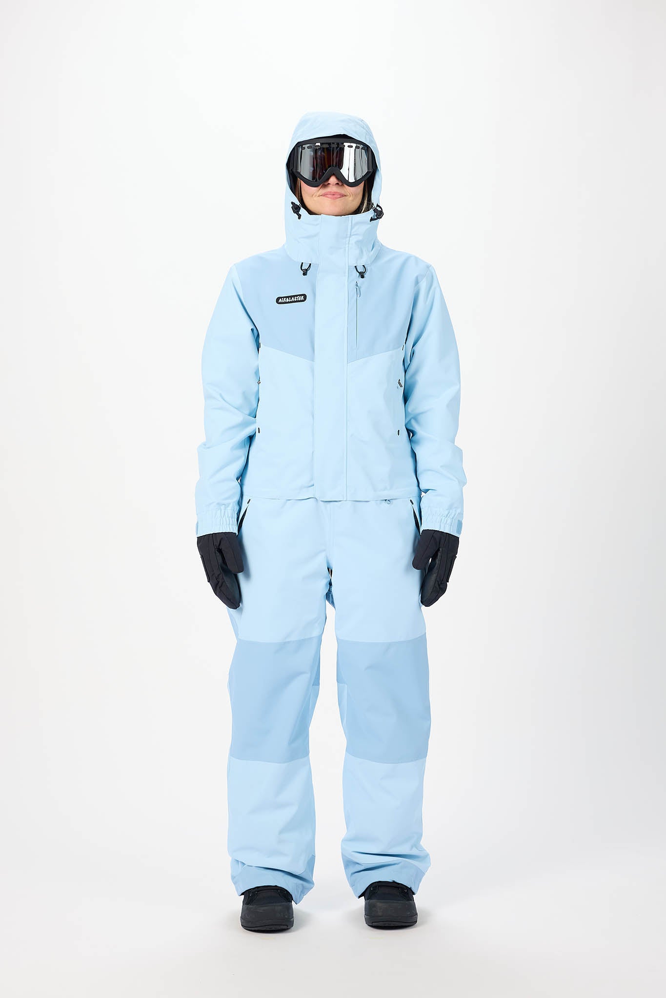 Person wearing a light blue snowsuit on a white background