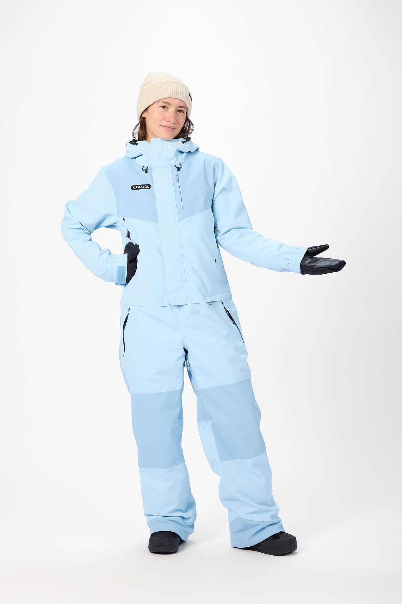 Person wearing a light blue snowsuit on a white background