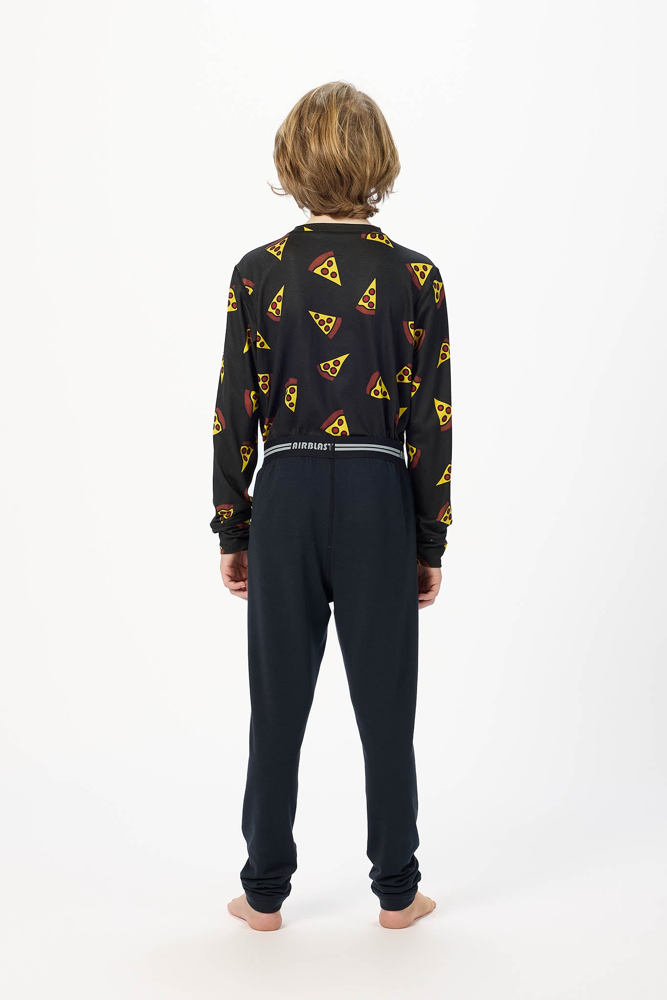 Youth model wearing black base layer bottoms,standing with his back facing the camera with a white background.