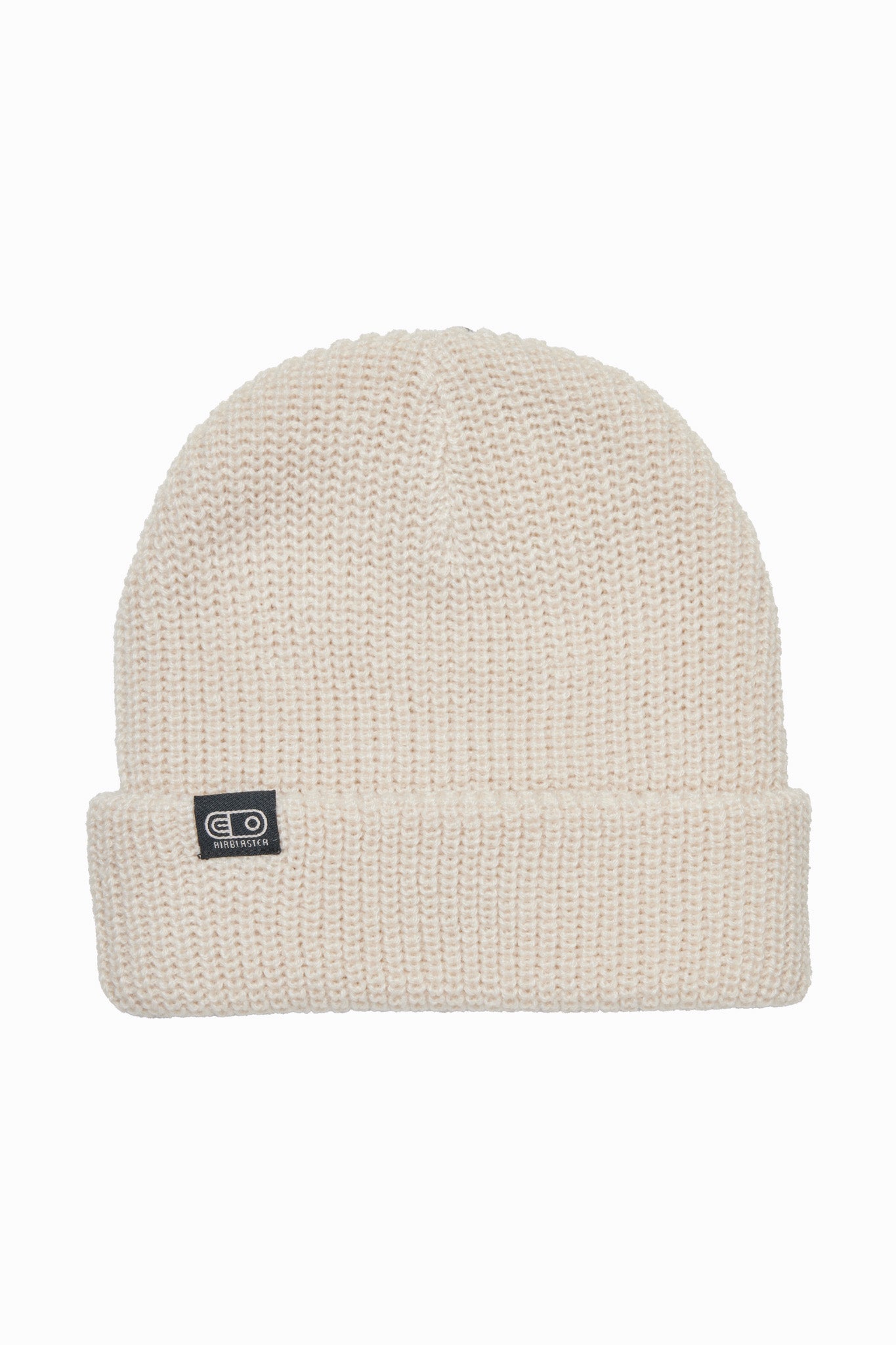 A cream-colored ribbed knit beanie hat with a folded cuff and a small black square logo patch on the front, set against a plain white background.