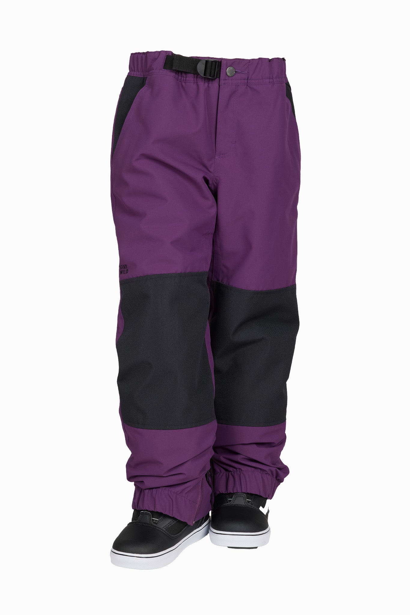 A pair of colorblock snow pants in purple and black, shown from the waist down on a white background with black snow boots.