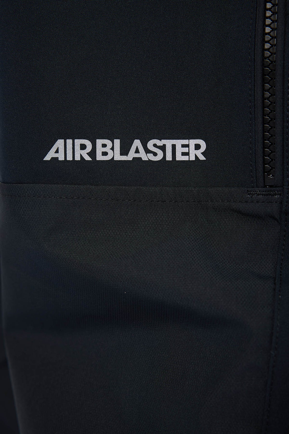 Black jacket with 'AIR BLASTER' logo on a dark background
