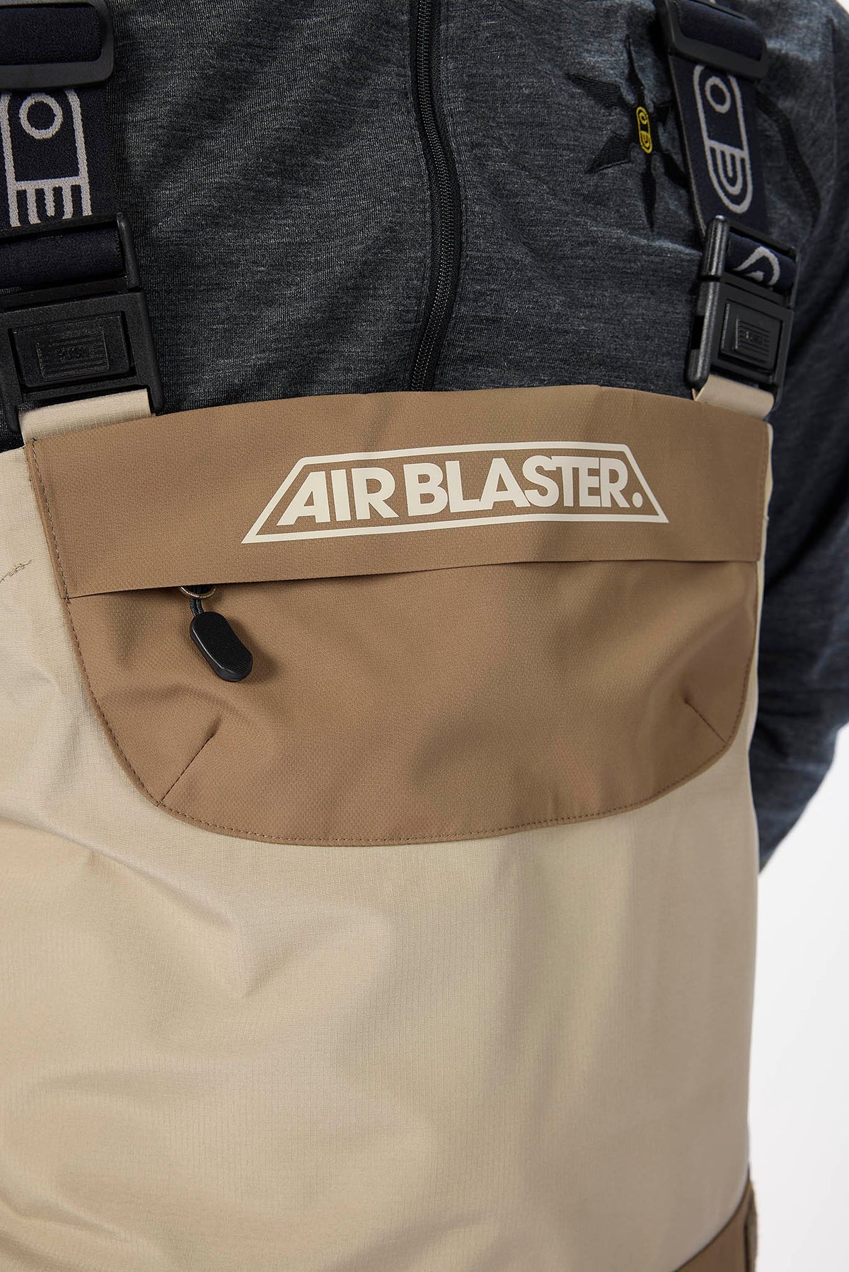 Beige pants with 'AIR BLASTER' logo on a white background