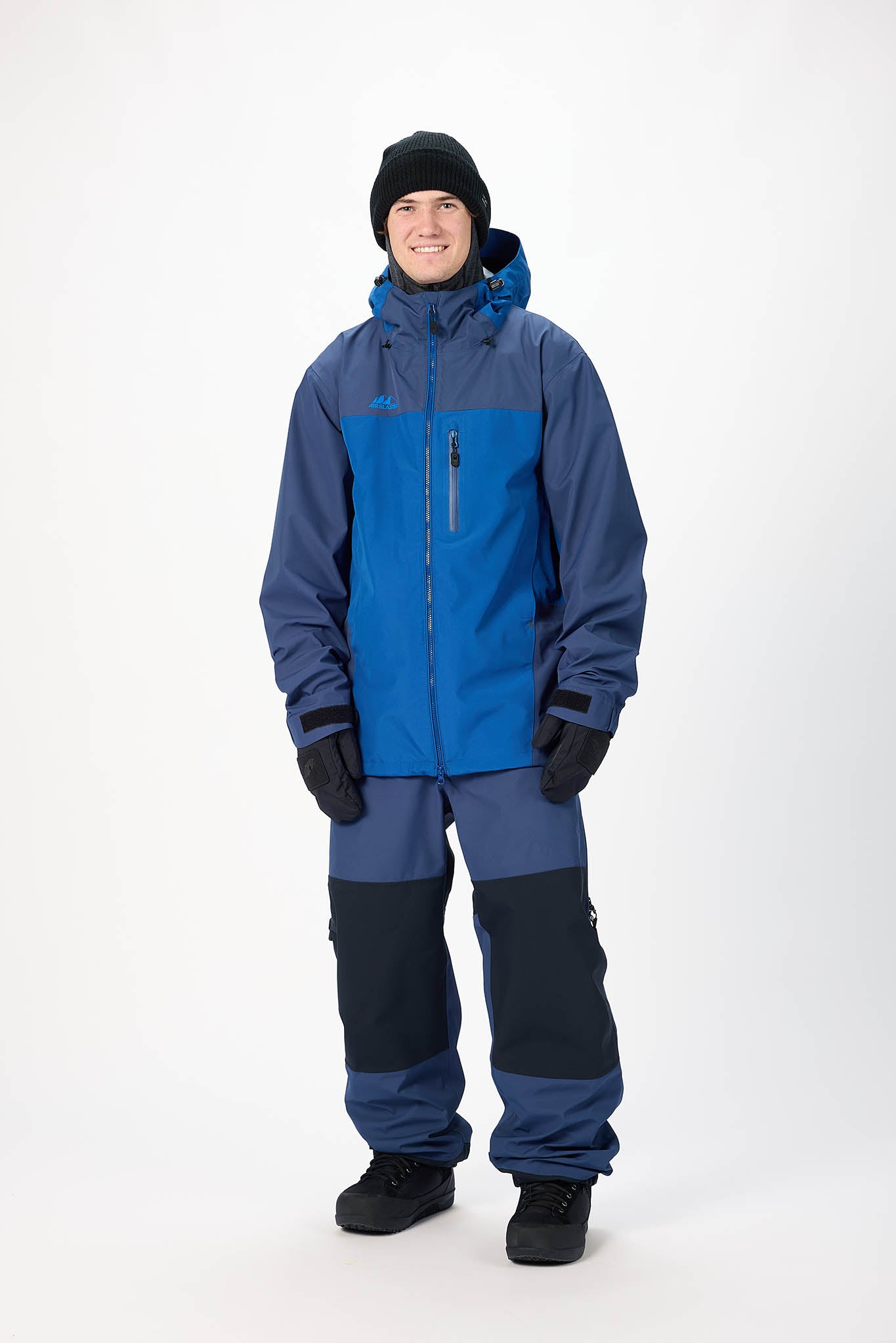 Person wearing a blue and gray snowsuit on a white background