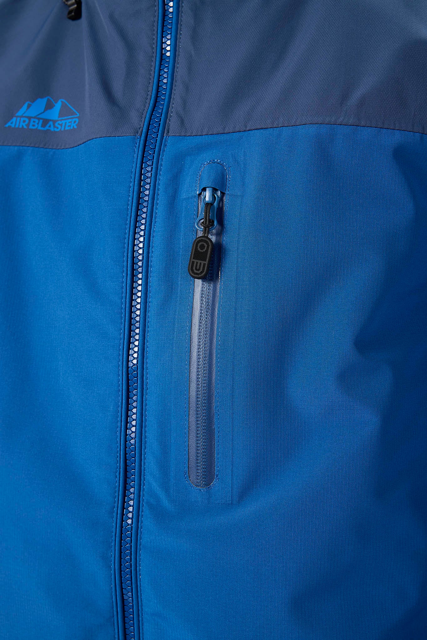 Close-up of a blue jacket with a zipper and Airblaster logo.