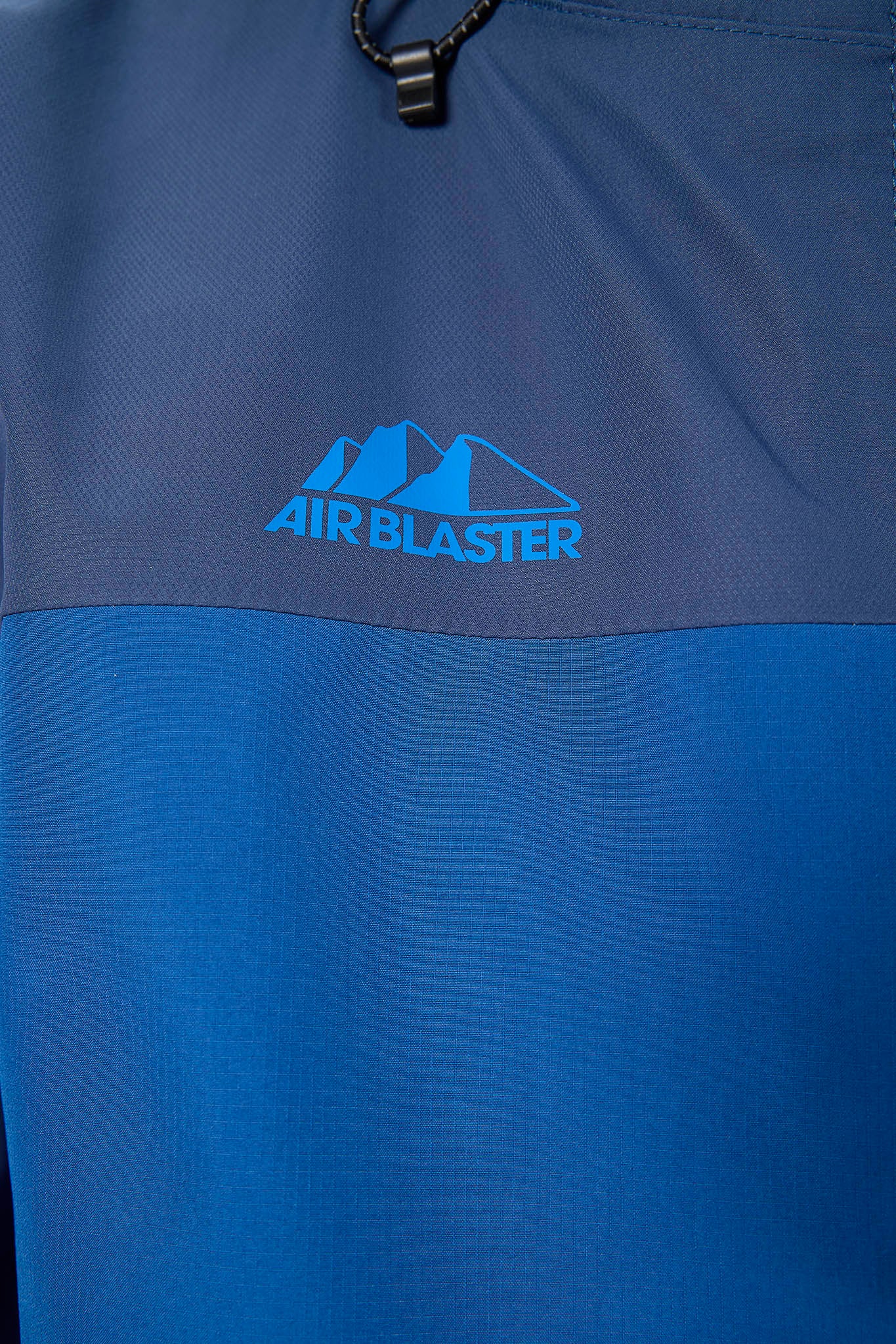 Blue fabric with Air Blaster logo on a close-up of clothing