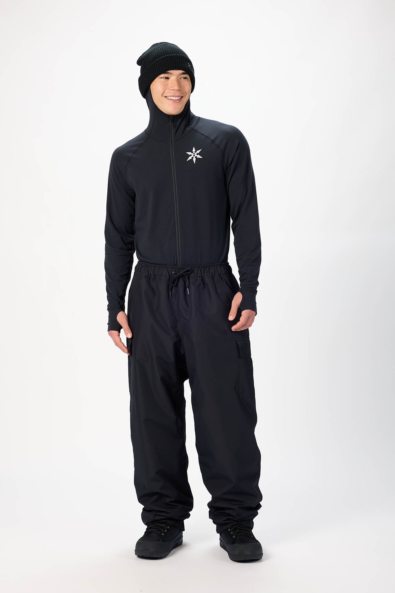 model wearing all black against a white background