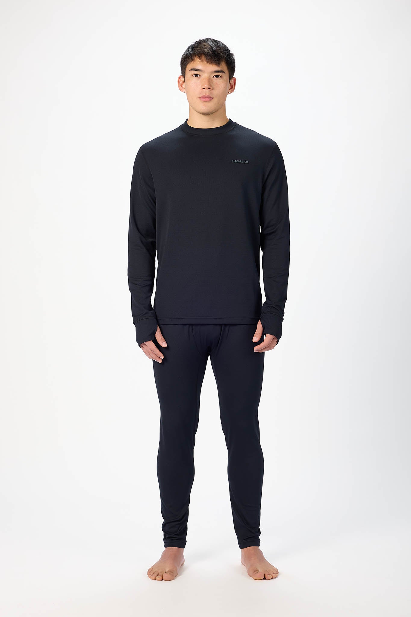A man modeling a dark navy long-sleeve crewneck shirt and matching dark navy full-length pants against a plain white studio background.