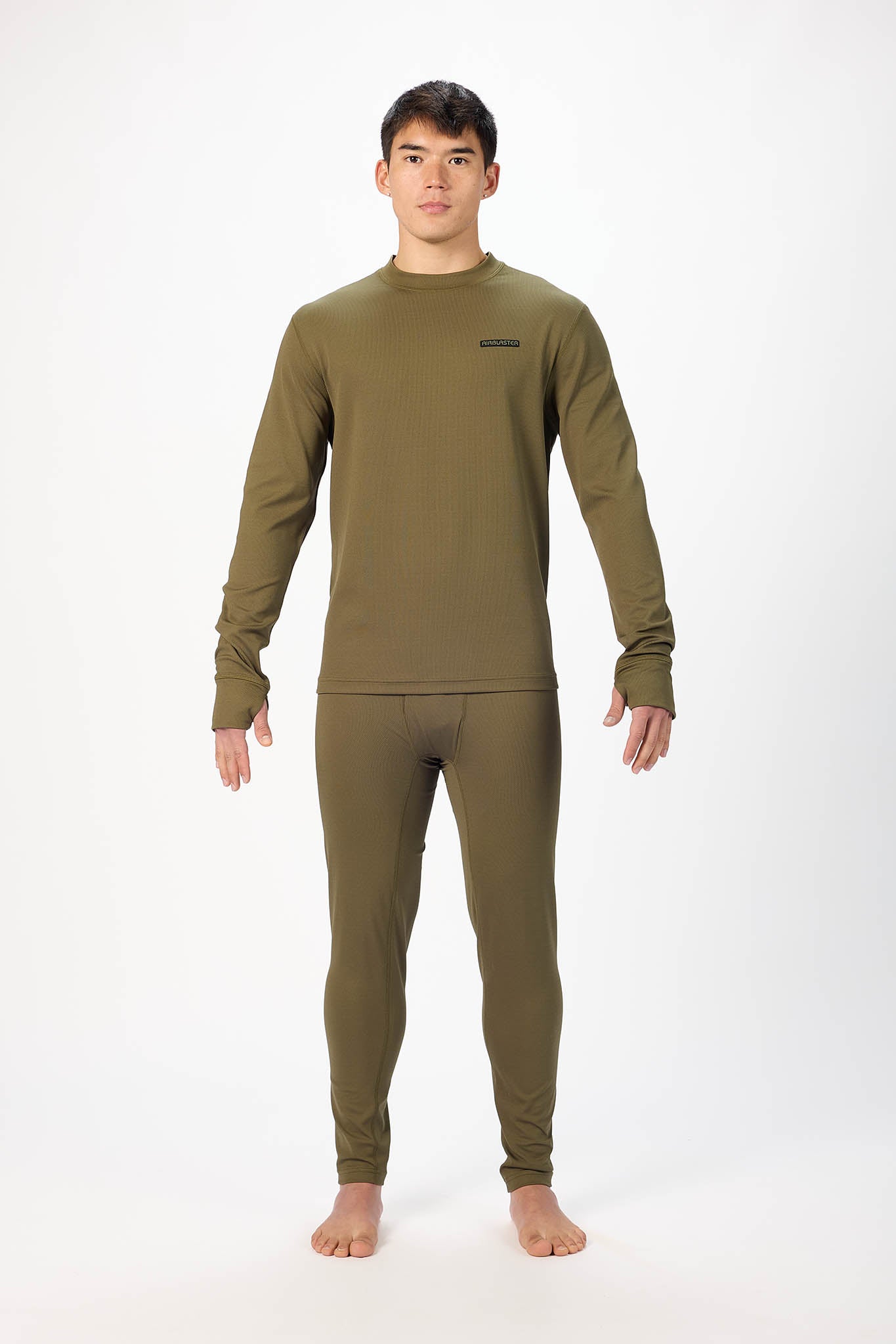 A man modeling a matching long-sleeve crewneck sweater and thermal pants set in olive green, standing against a plain white studio background.