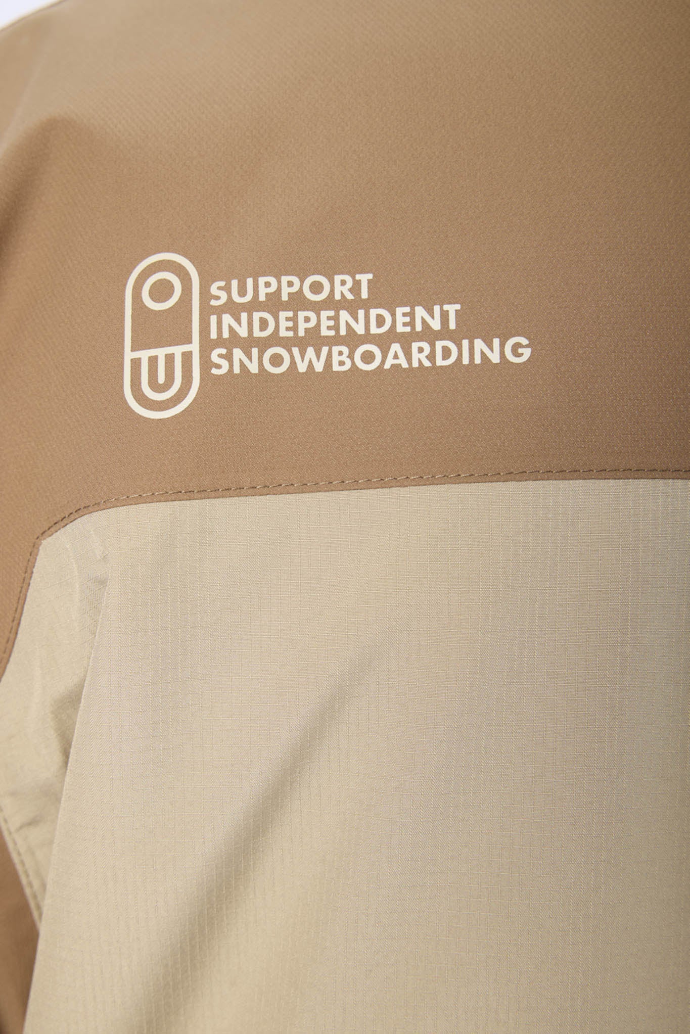 close up of beige jacket and air blaster logo
