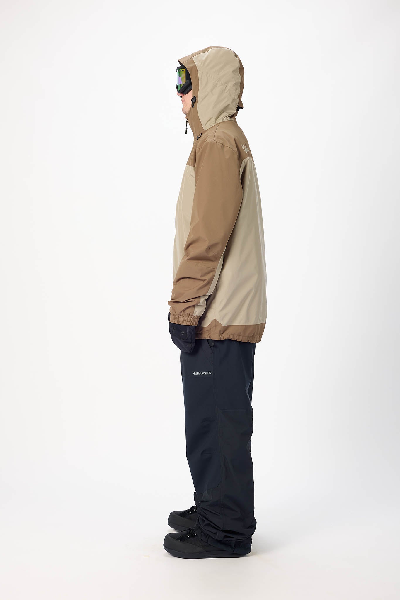 Person wearing a two-tone jacket and pants on a white background