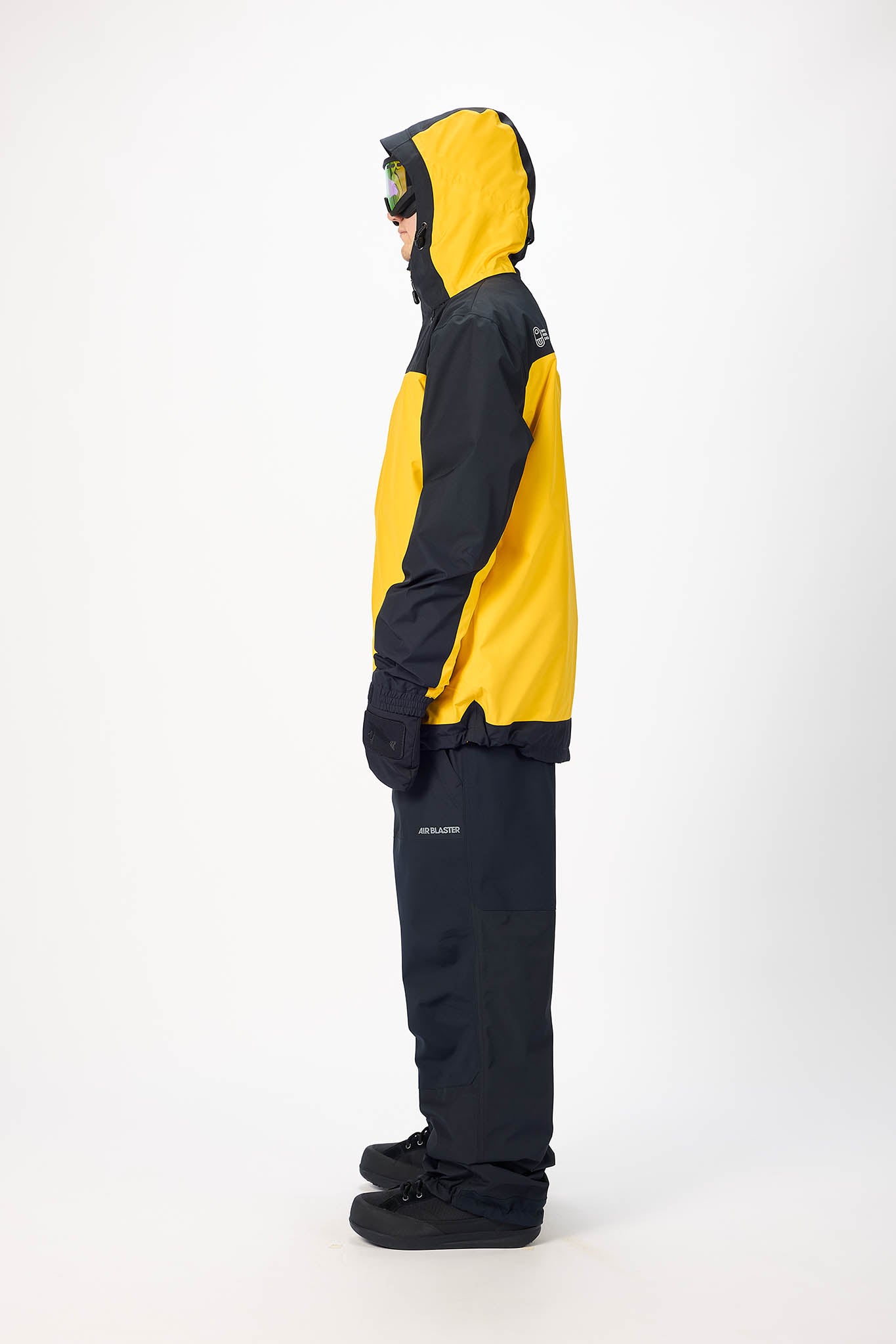 Person wearing a yellow and black snowsuit on a white background