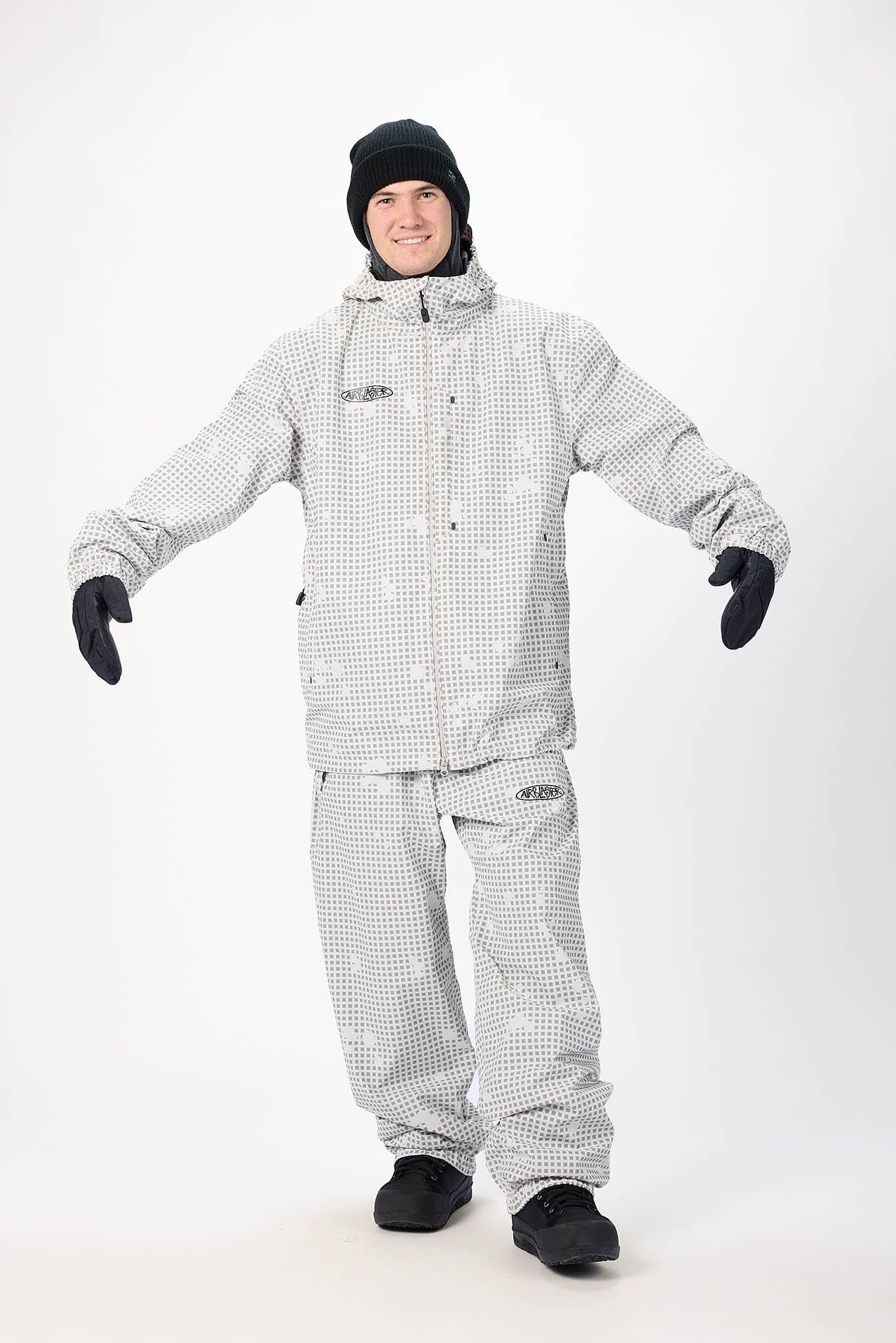Person wearing a gray checkered snowsuit on a white background
