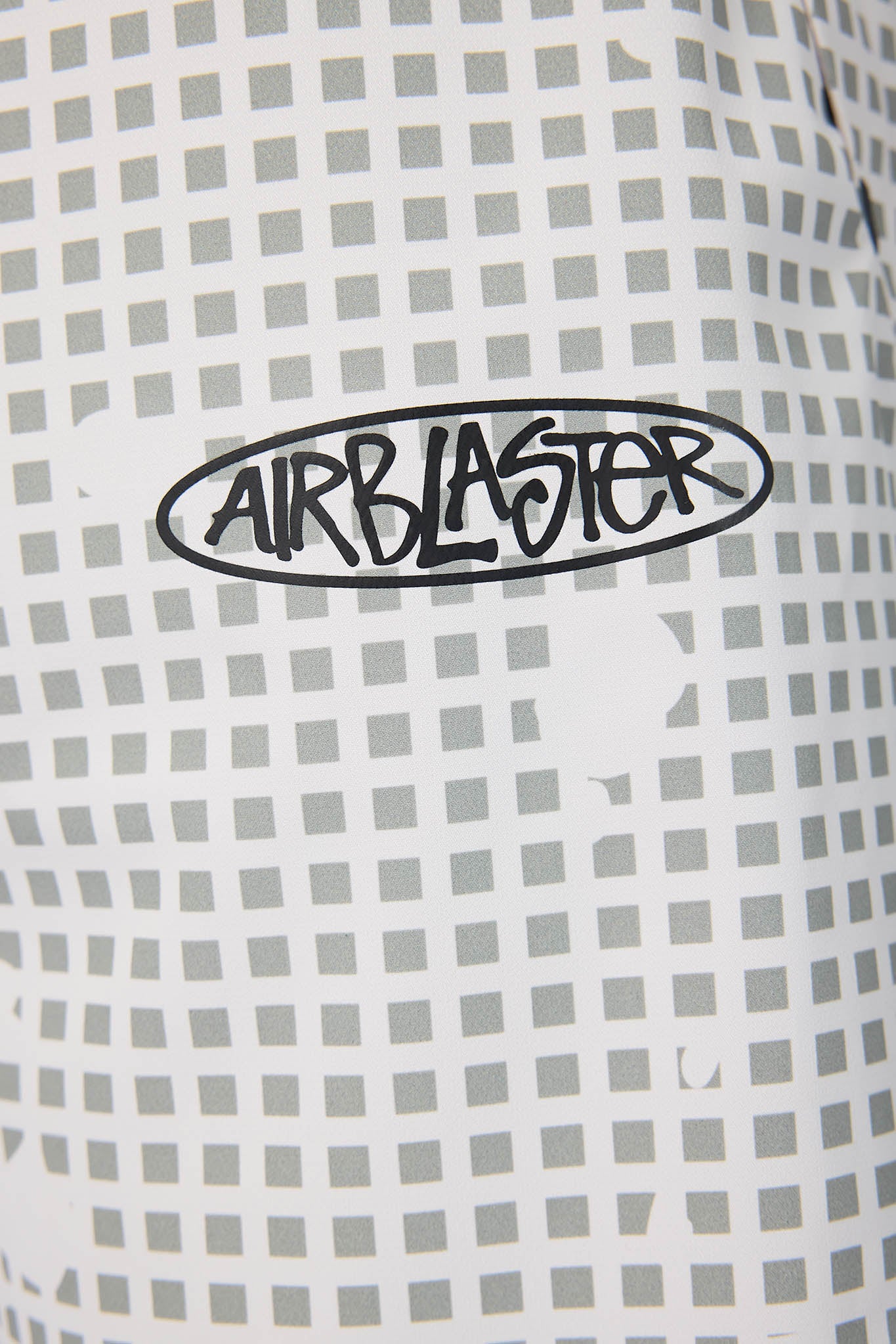 Close-up of an Airblaster logo on a checkered background