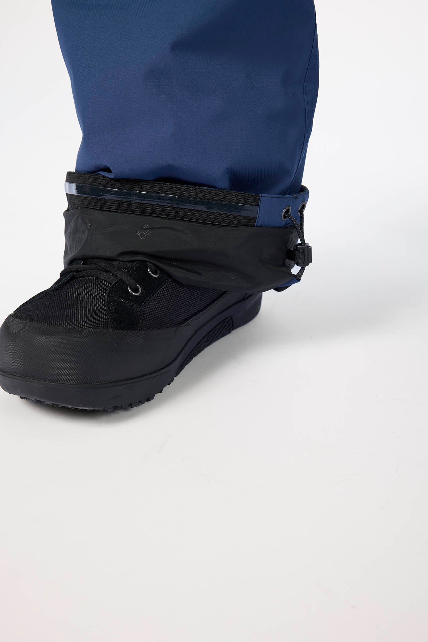Black boot with a zipped compartment on a white background