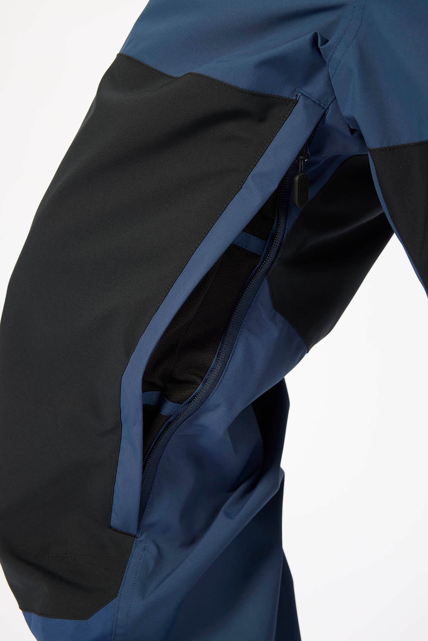 Close-up of a blue and black jacket with a white background