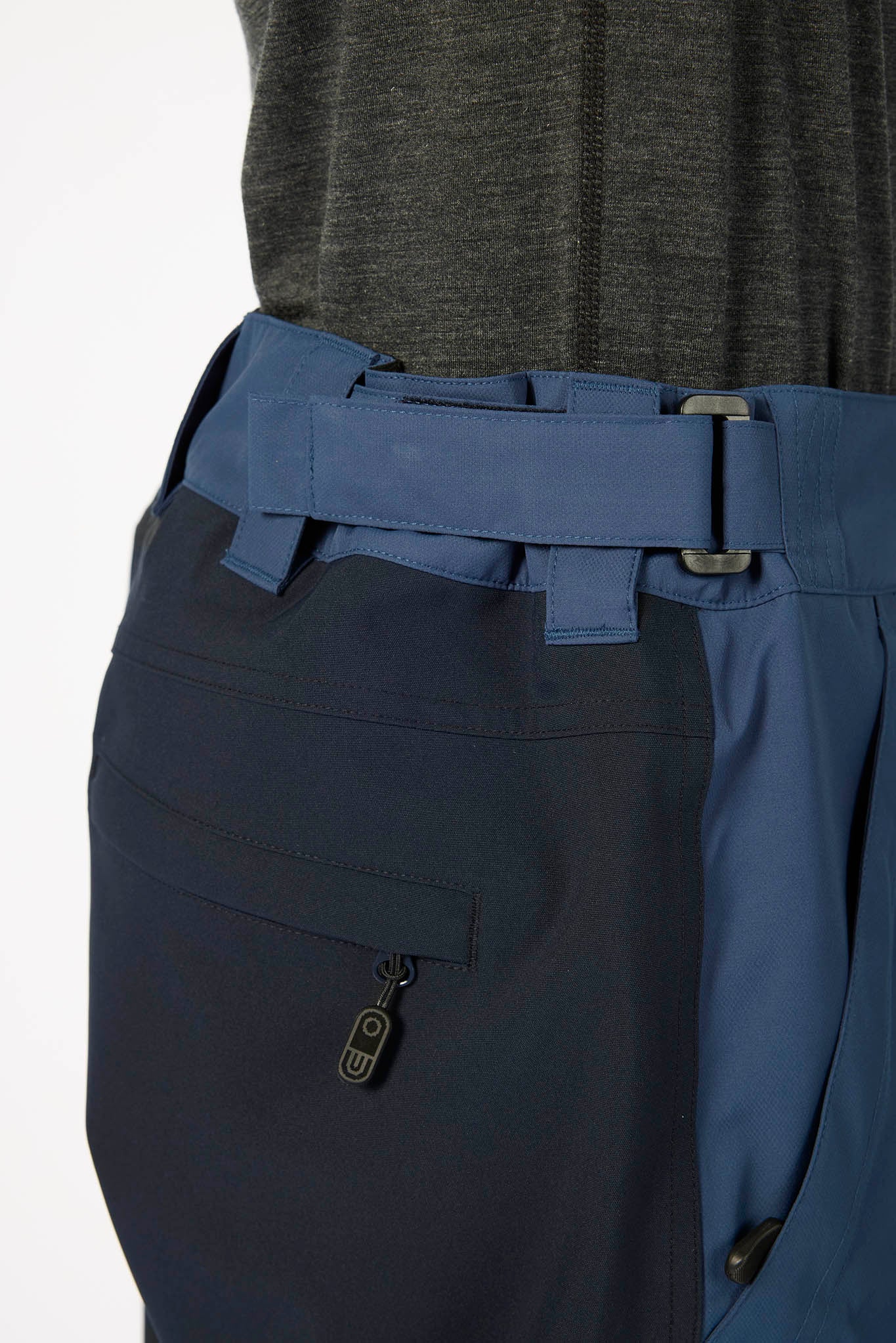 Blue pants with a belt and visible brand logo on a white background