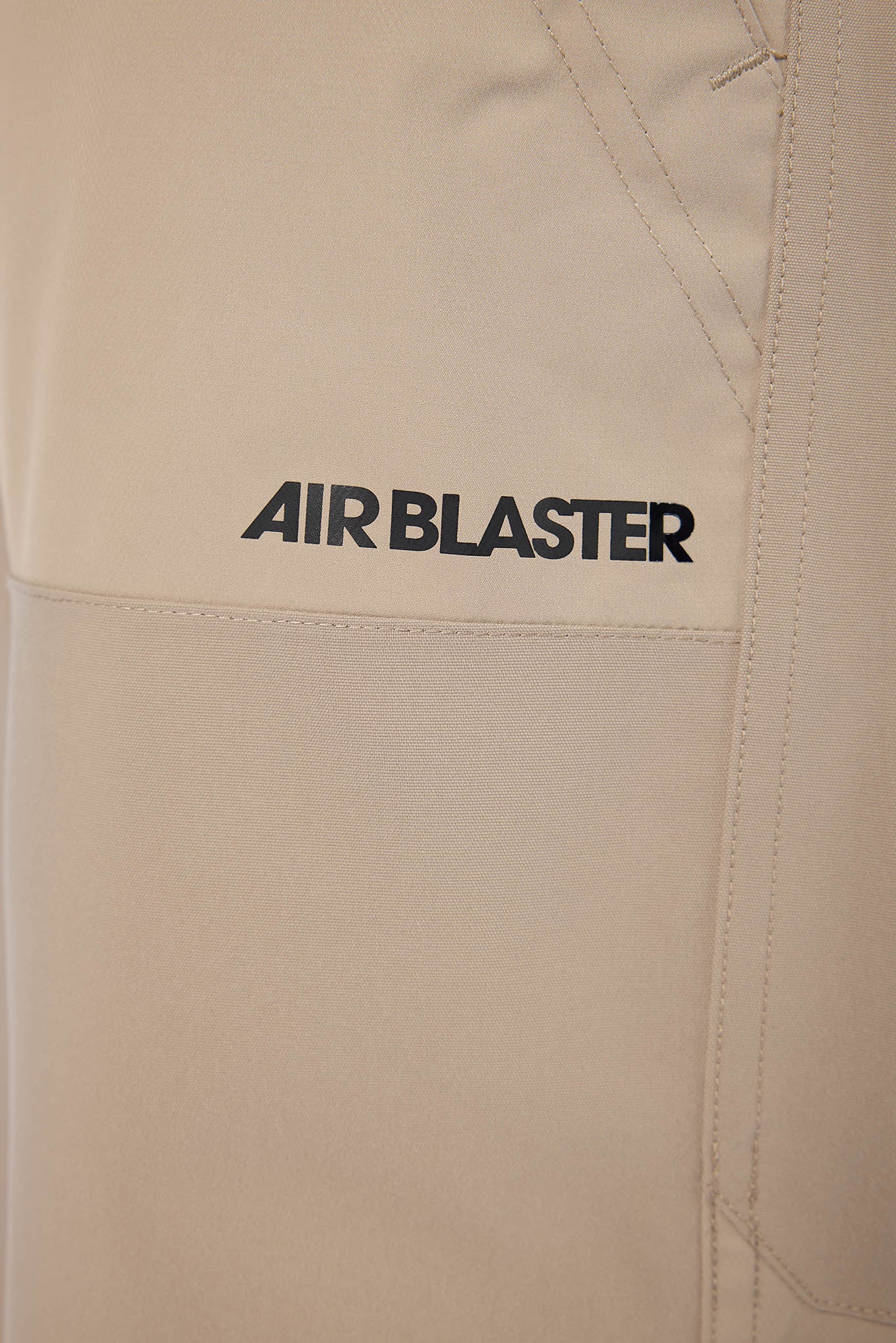 Beige jacket with 'AIR BLASTER' logo on a beige background