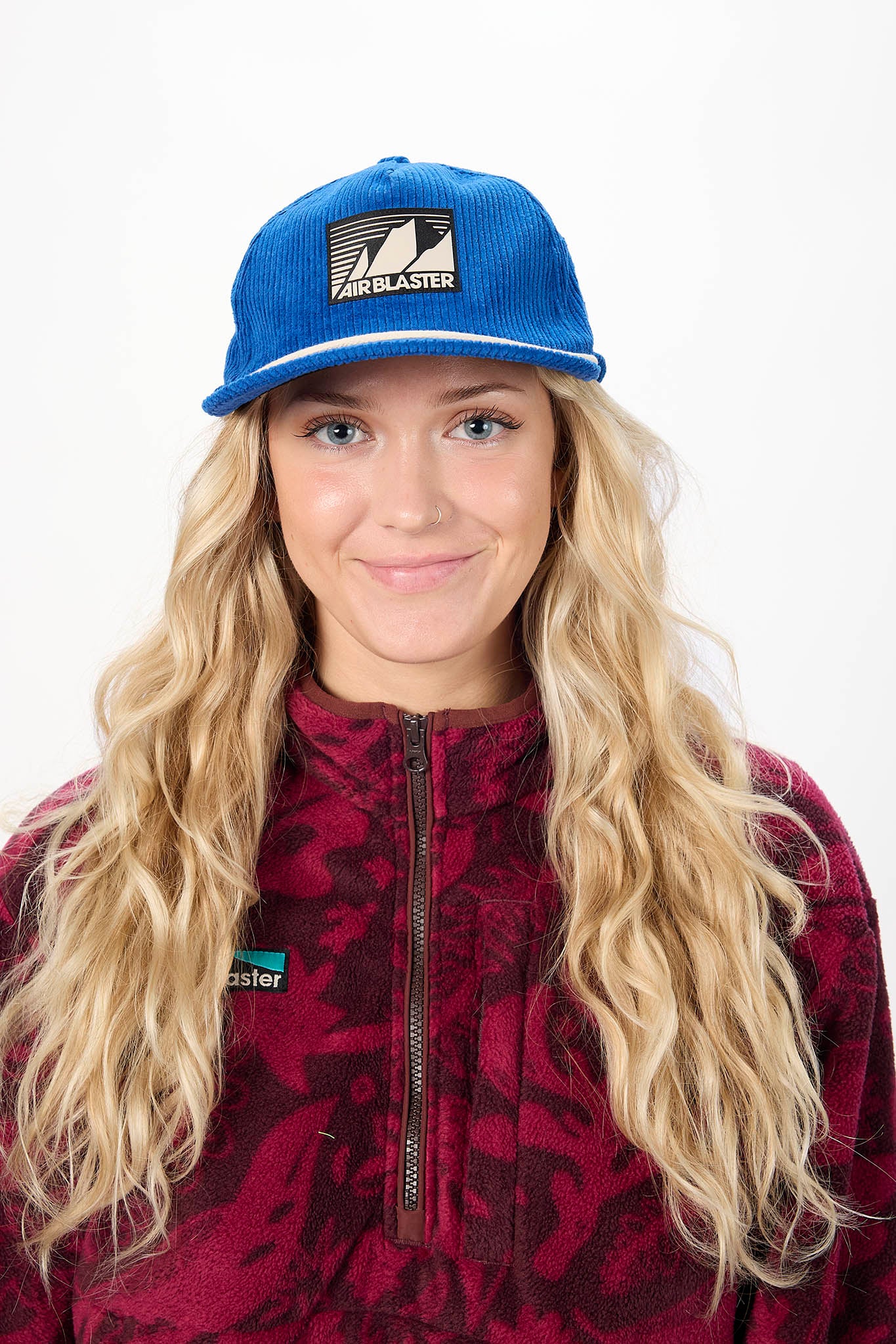 woman wearing a blue Airblaster baseball cap