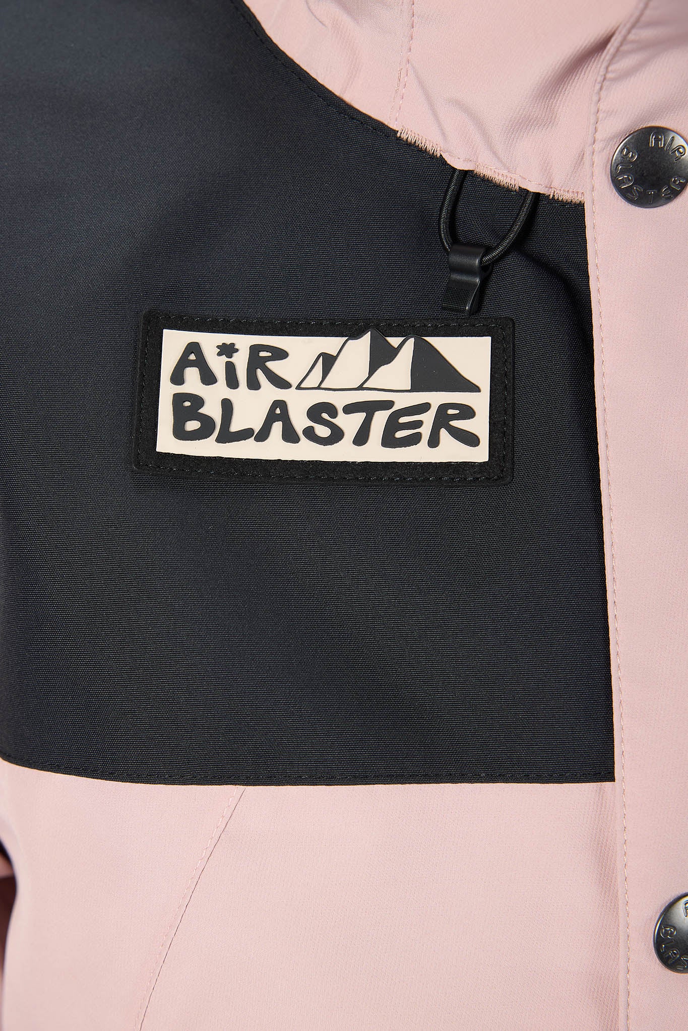 Close-up of a jacket with 'Air Blaster' logo on a black patch.