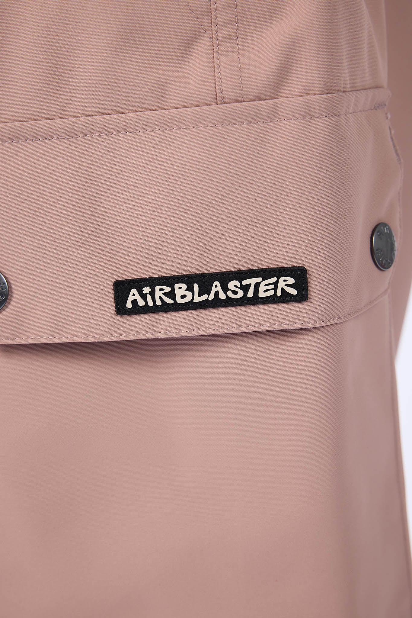 Close-up of a beige jacket with an 'Airblaster' label.