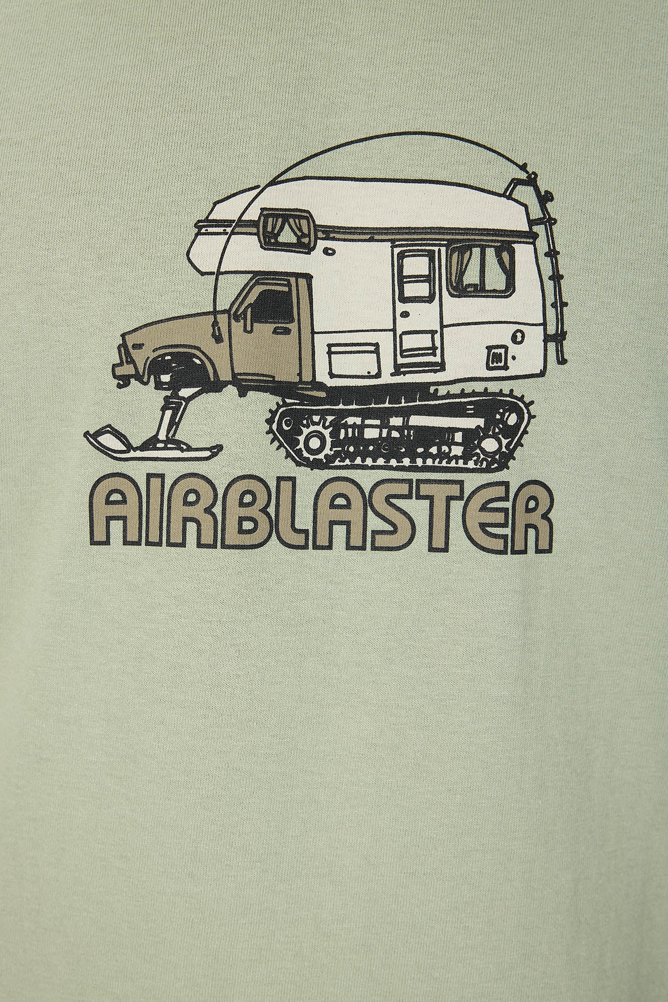A close-up of a light sage green t-shirt featuring a graphic of a snowmobile camper truck with the word 'AIRBLASTER' printed below it.