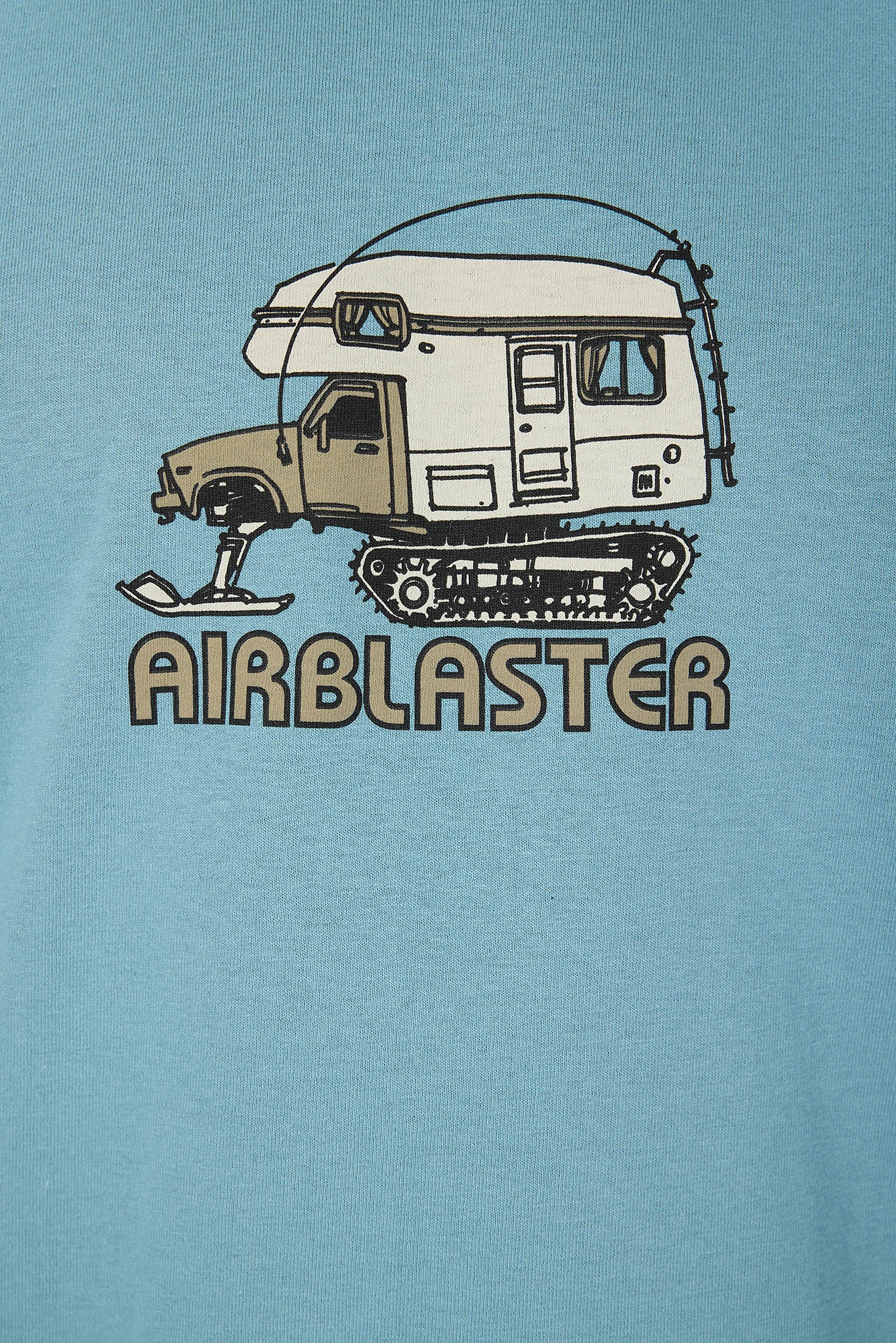A close-up of a light blue t-shirt featuring a graphic print of a snowmobile camper with the word 'AIRBLASTER' printed below it.