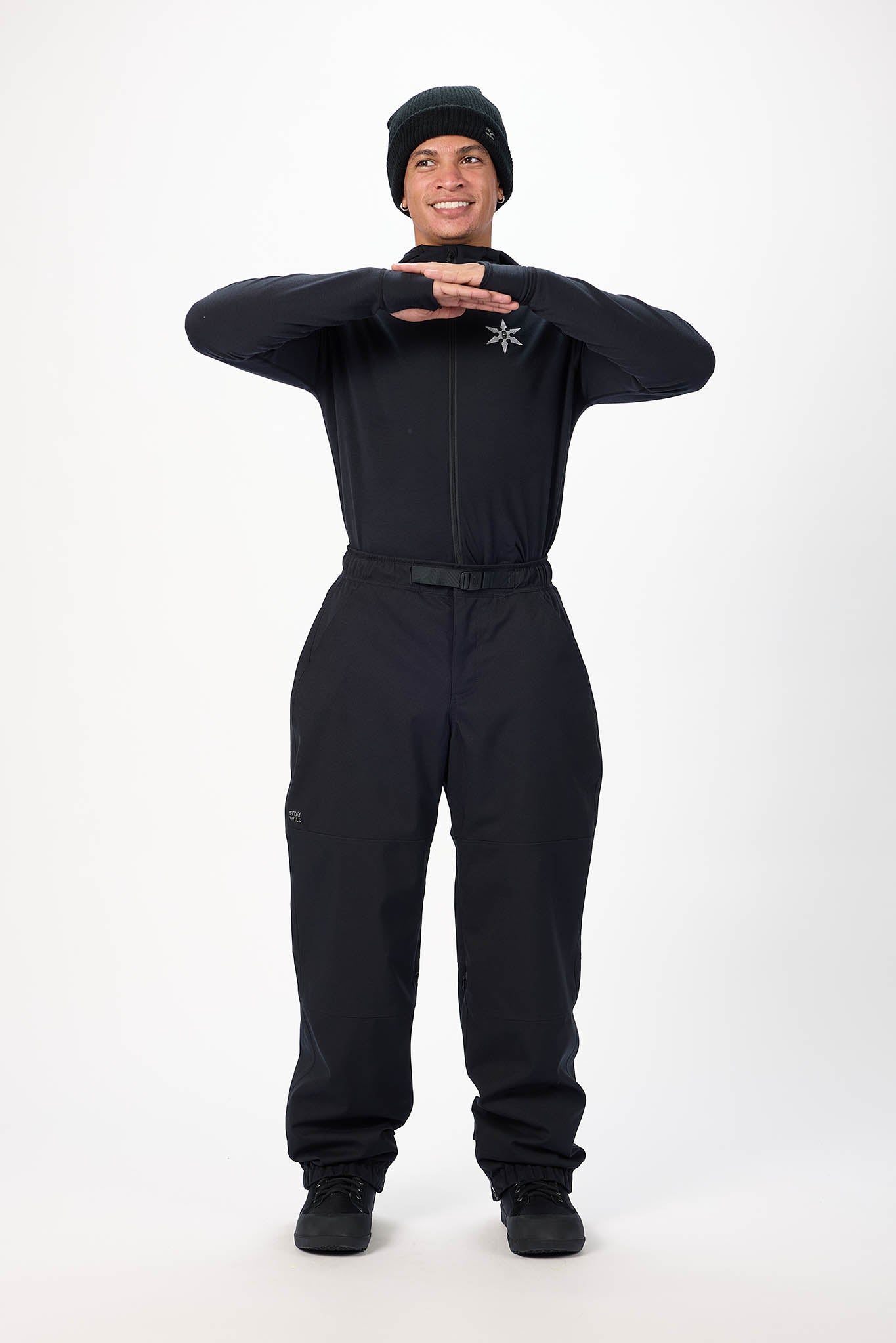Person wearing a black snowsuit on a white background