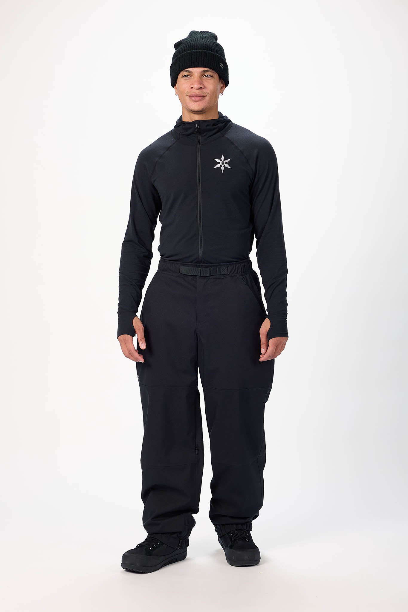 Person wearing a black outfit with a logo on a white background