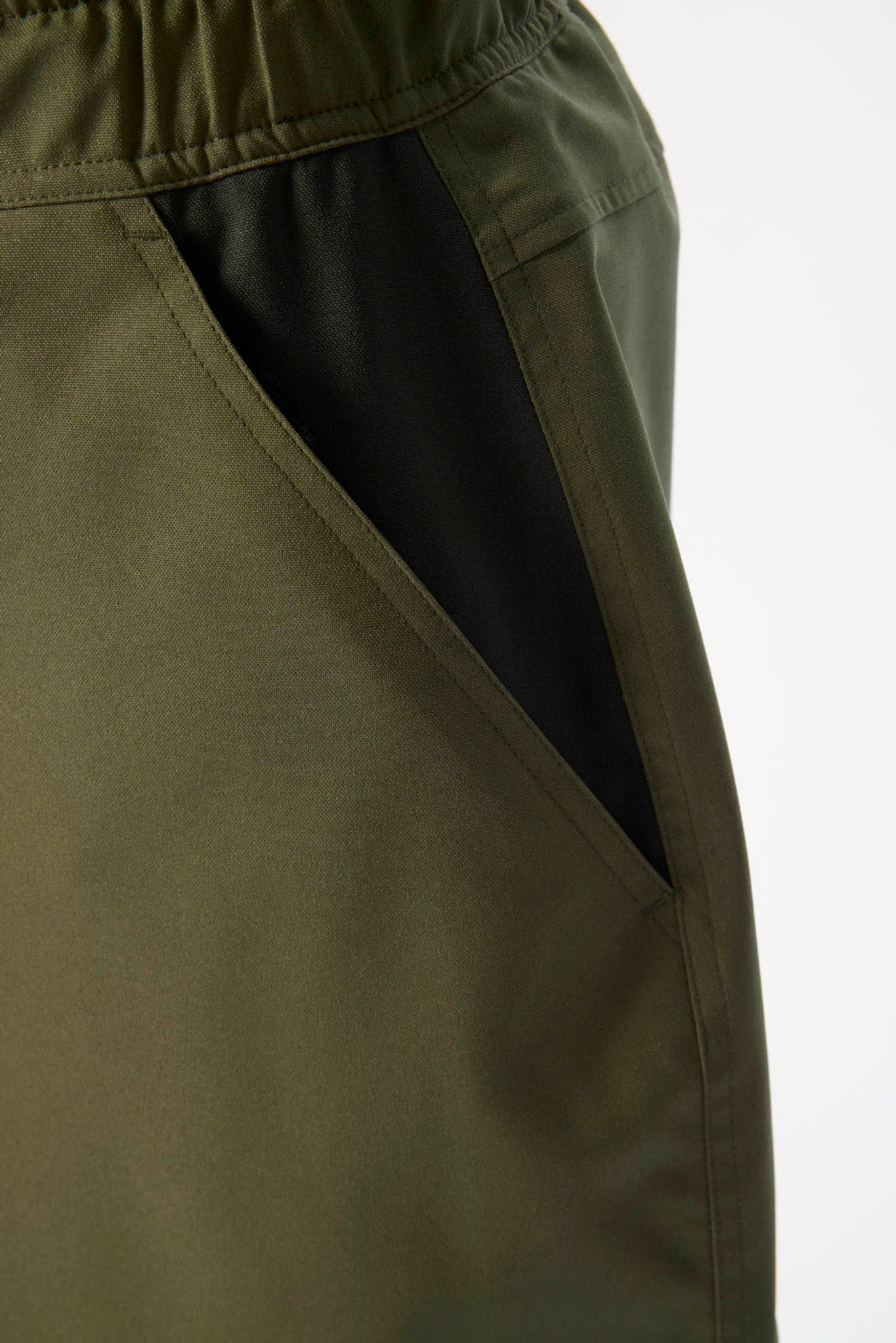 Close-up of a green jacket with a black lining on a white background