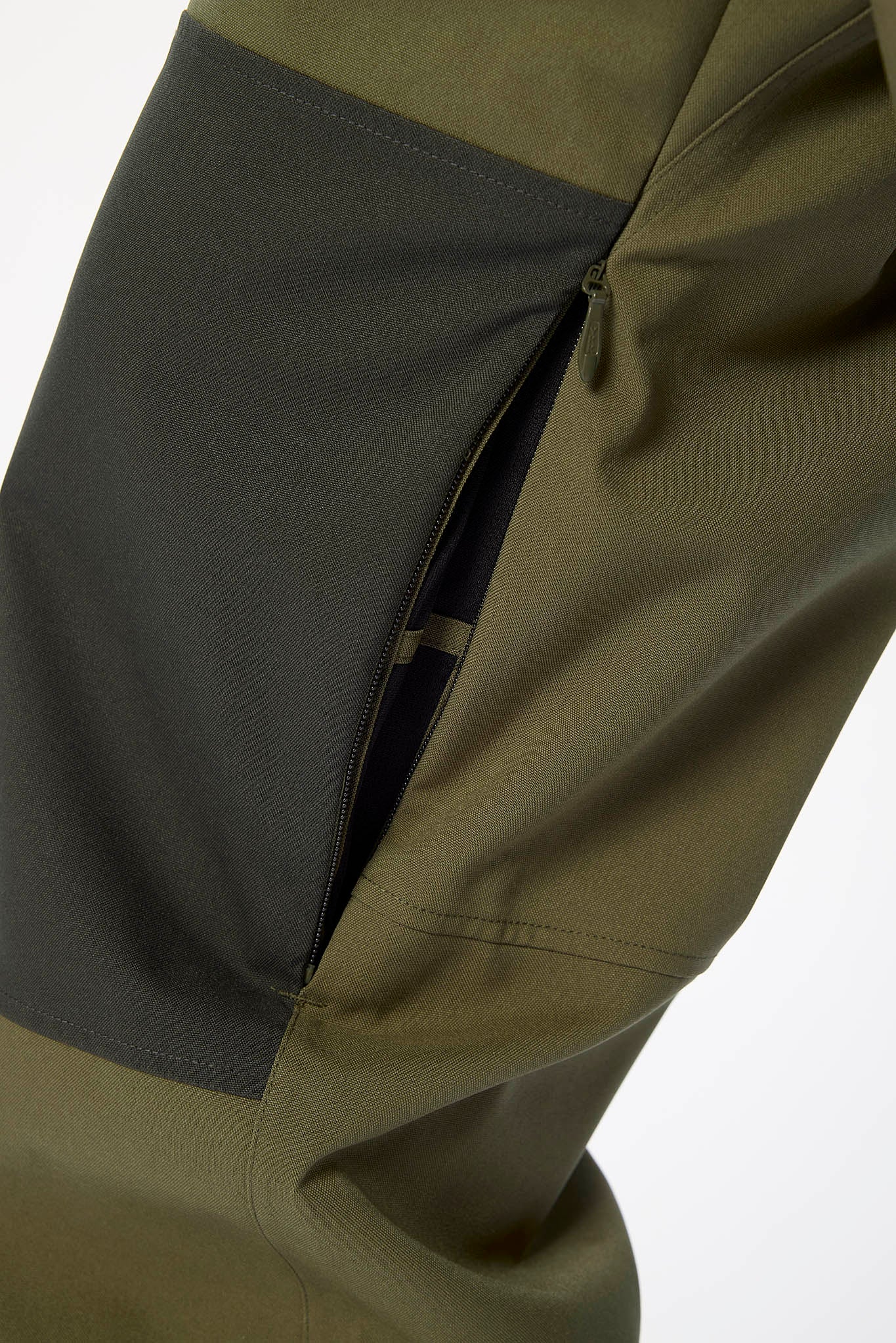 Close-up of a green and gray jacket with a pocket open on a white background