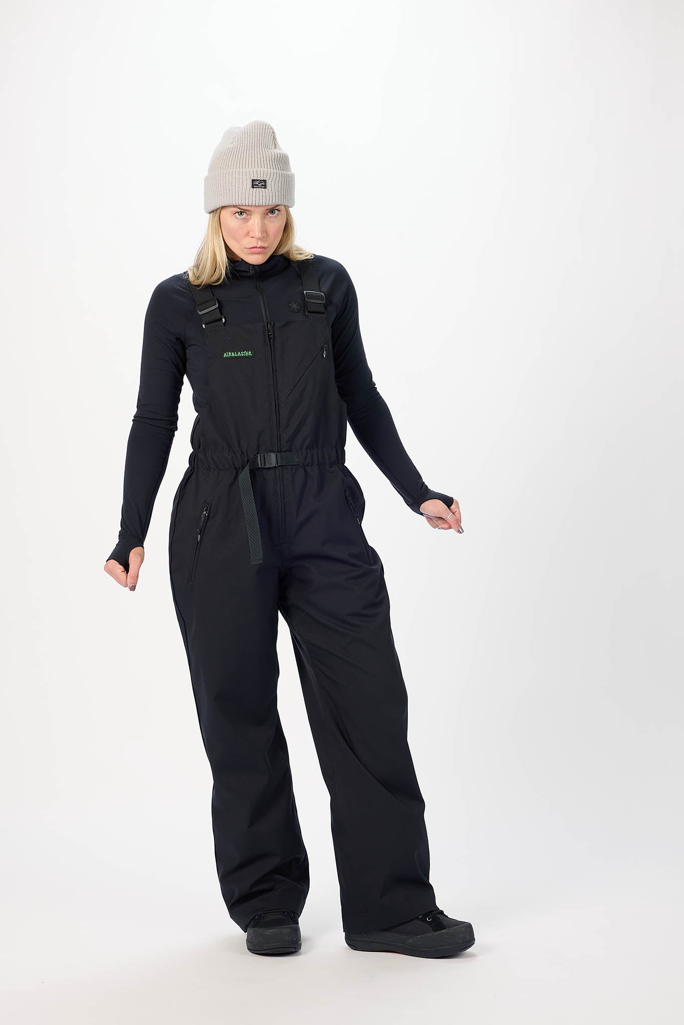 Person wearing a black snowsuit with a white background