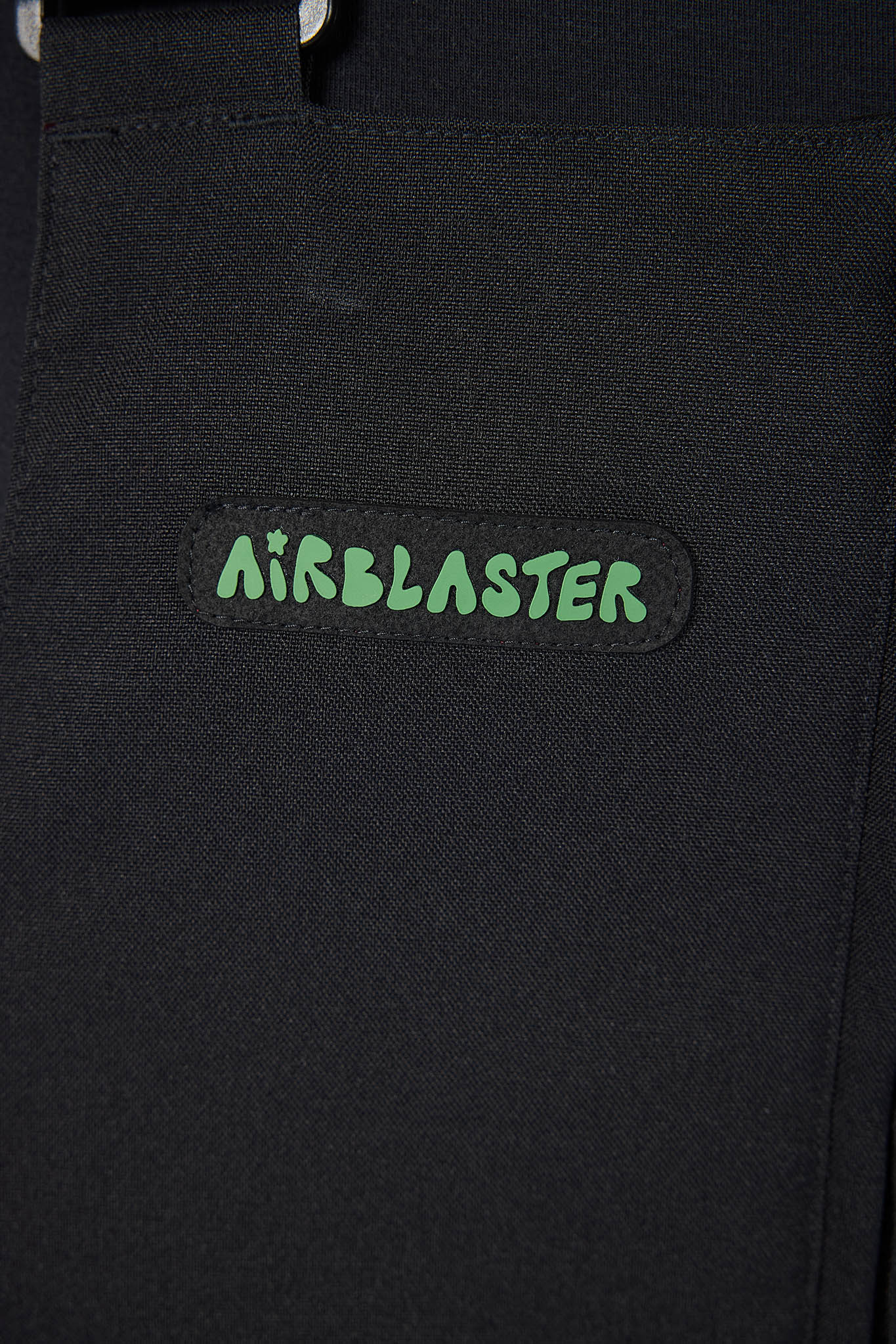 Black jacket with 'Airblaster' logo on a dark background