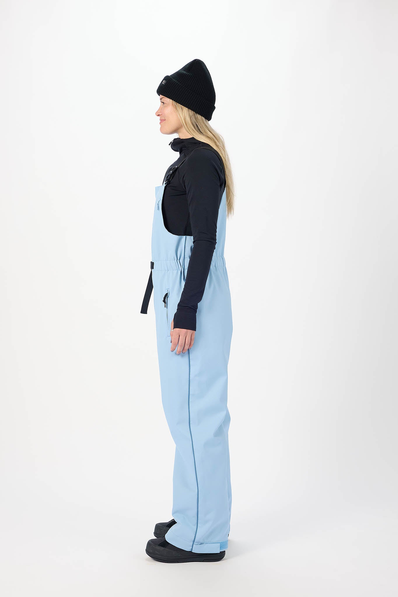 Person wearing a light blue snowsuit with black accents on a white background