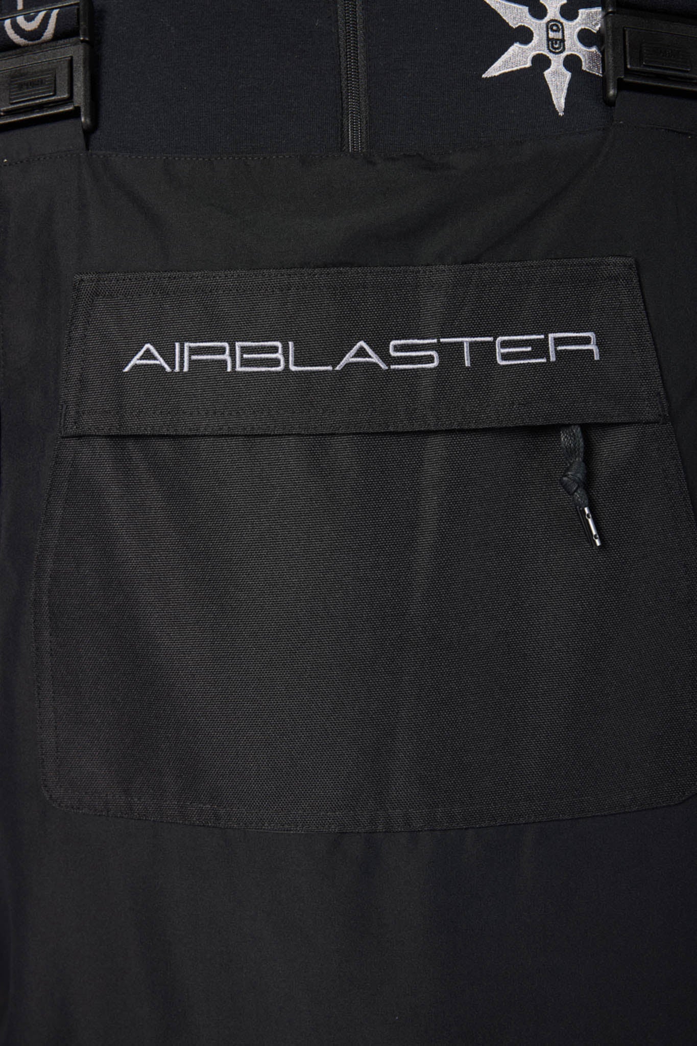 Black jacket with 'AIRBLASTER' logo on a pocket
