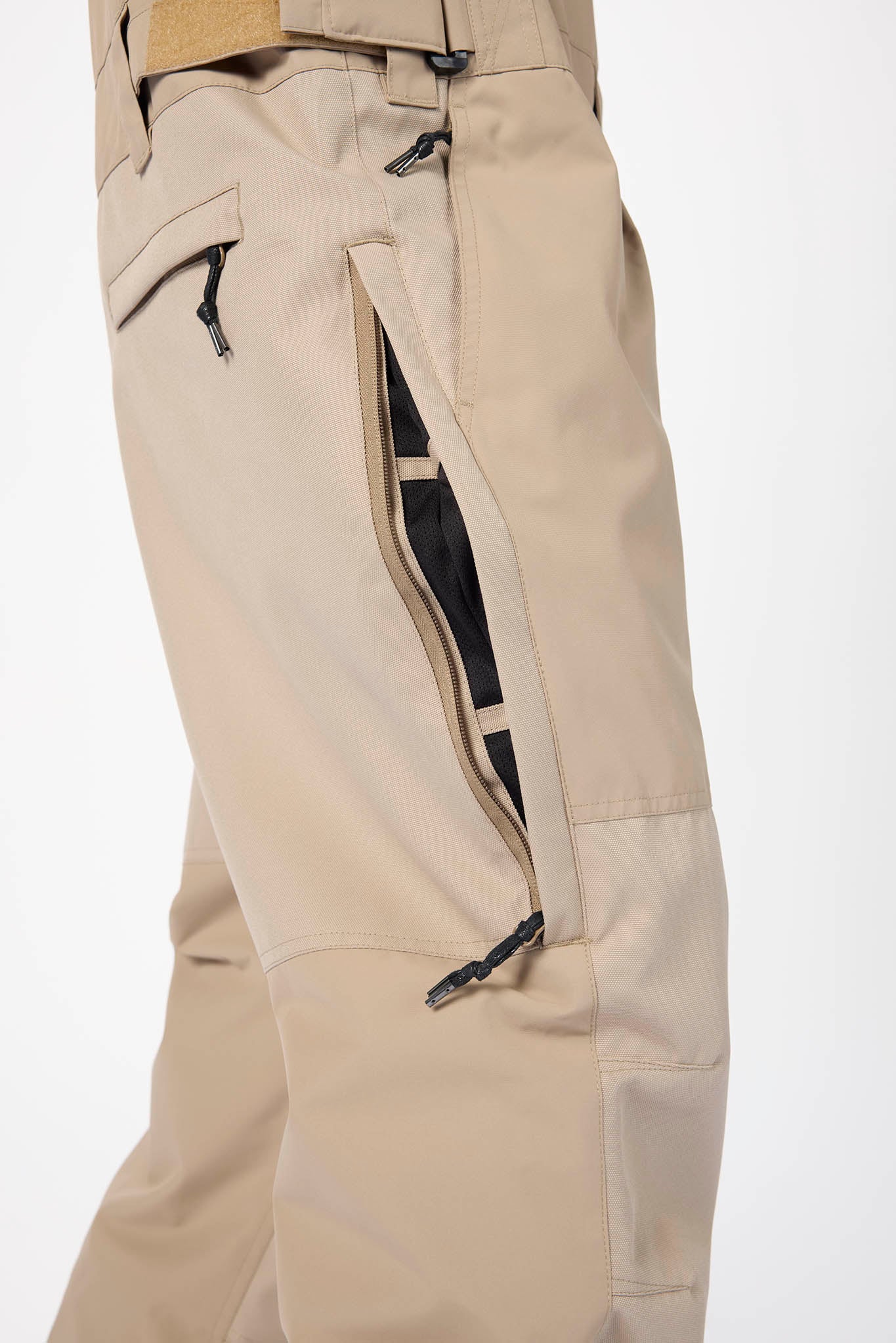 Beige pants with black accents on a white background
