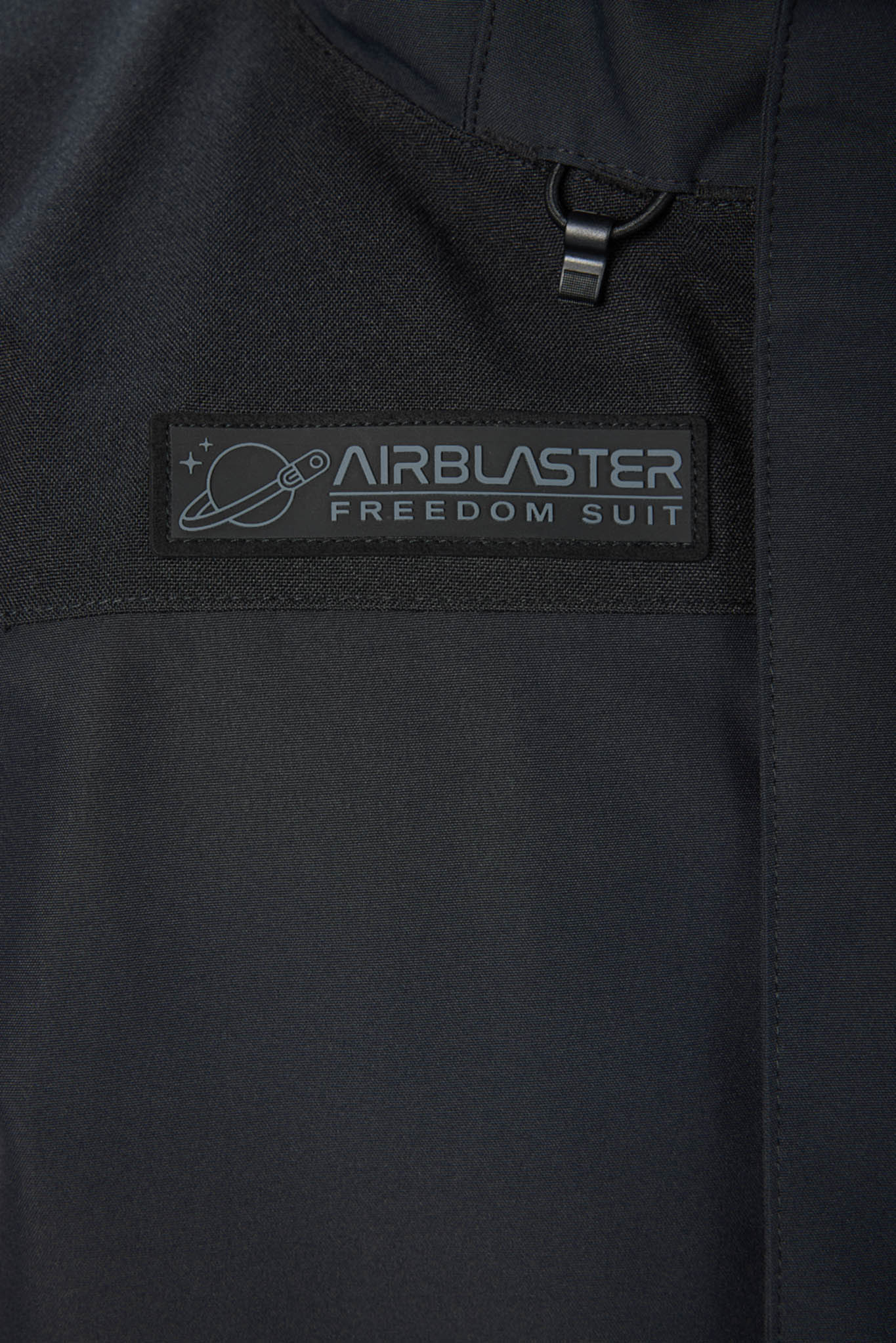 Black jacket with Airblaster Freedom Suit logo on a dark background