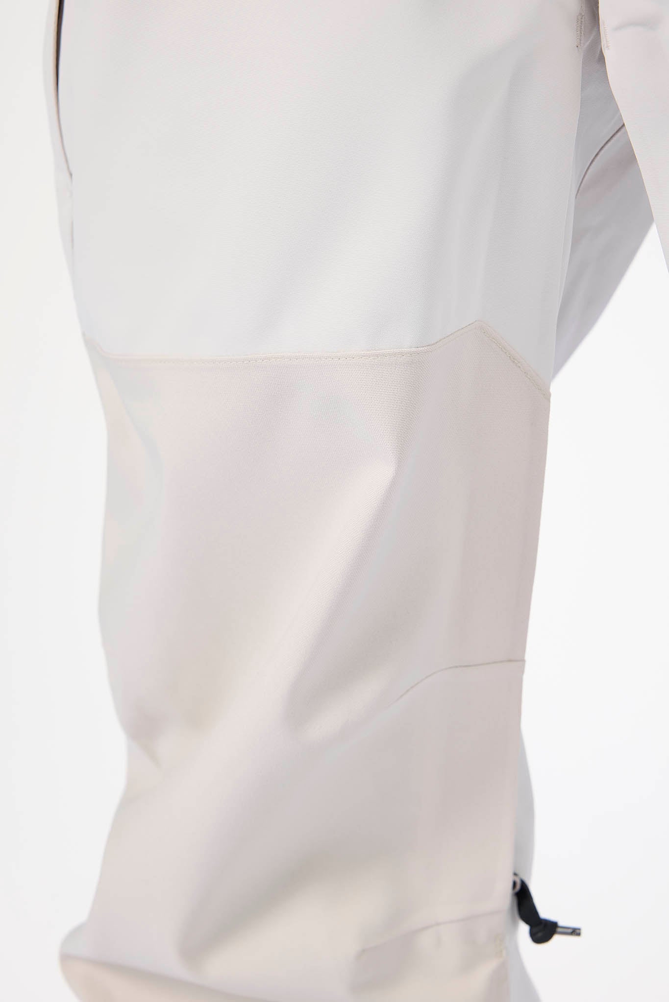 Close-up of a light gray jacket with a zipper on a white background