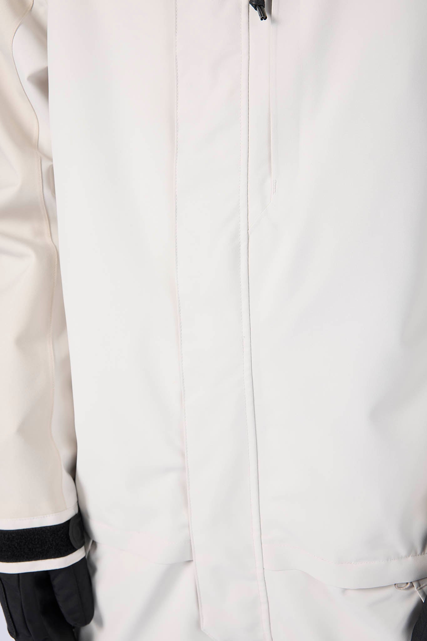 Close-up of a white jacket with black accents on a light gray background