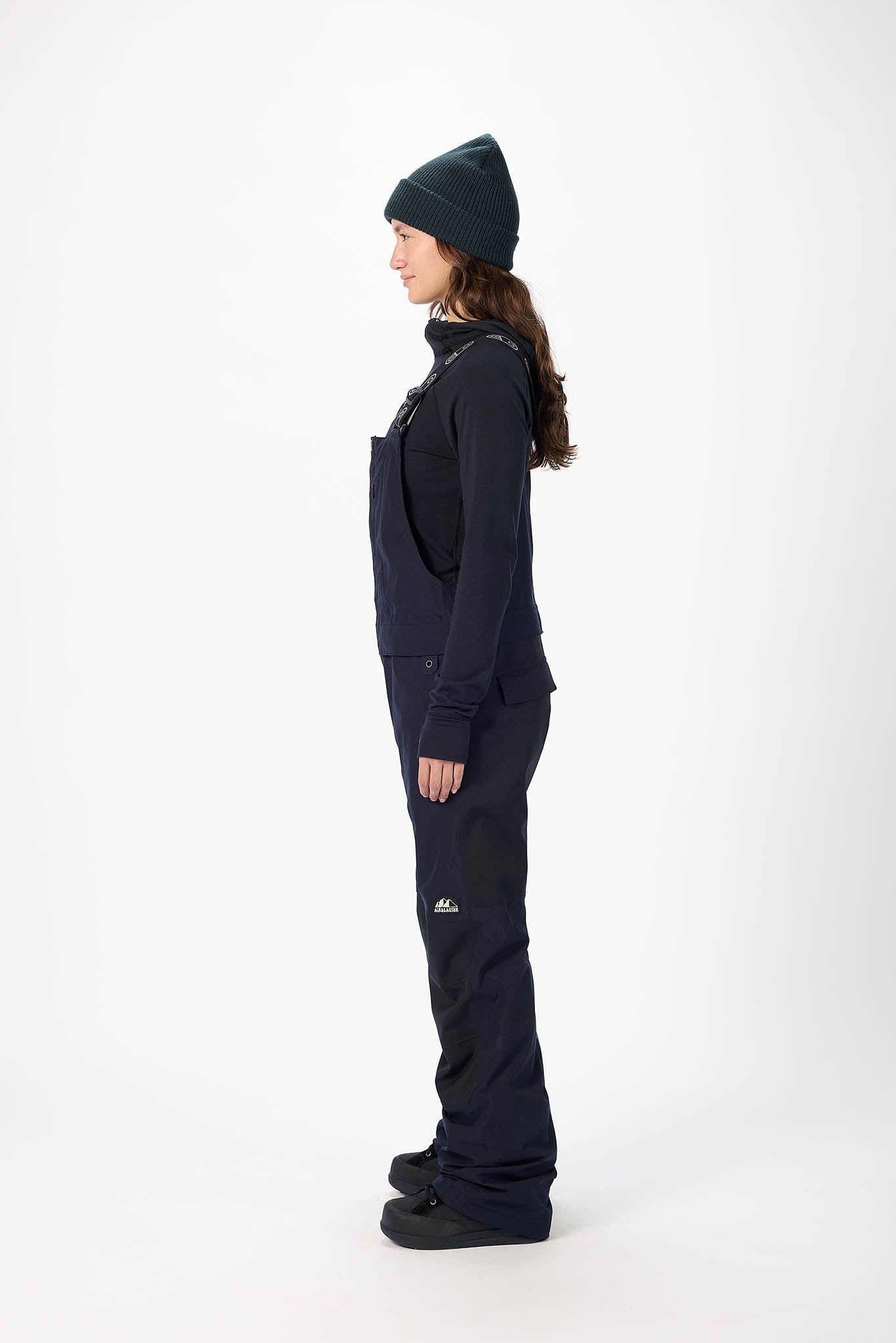 Person wearing a black snowsuit with a hood on a white background