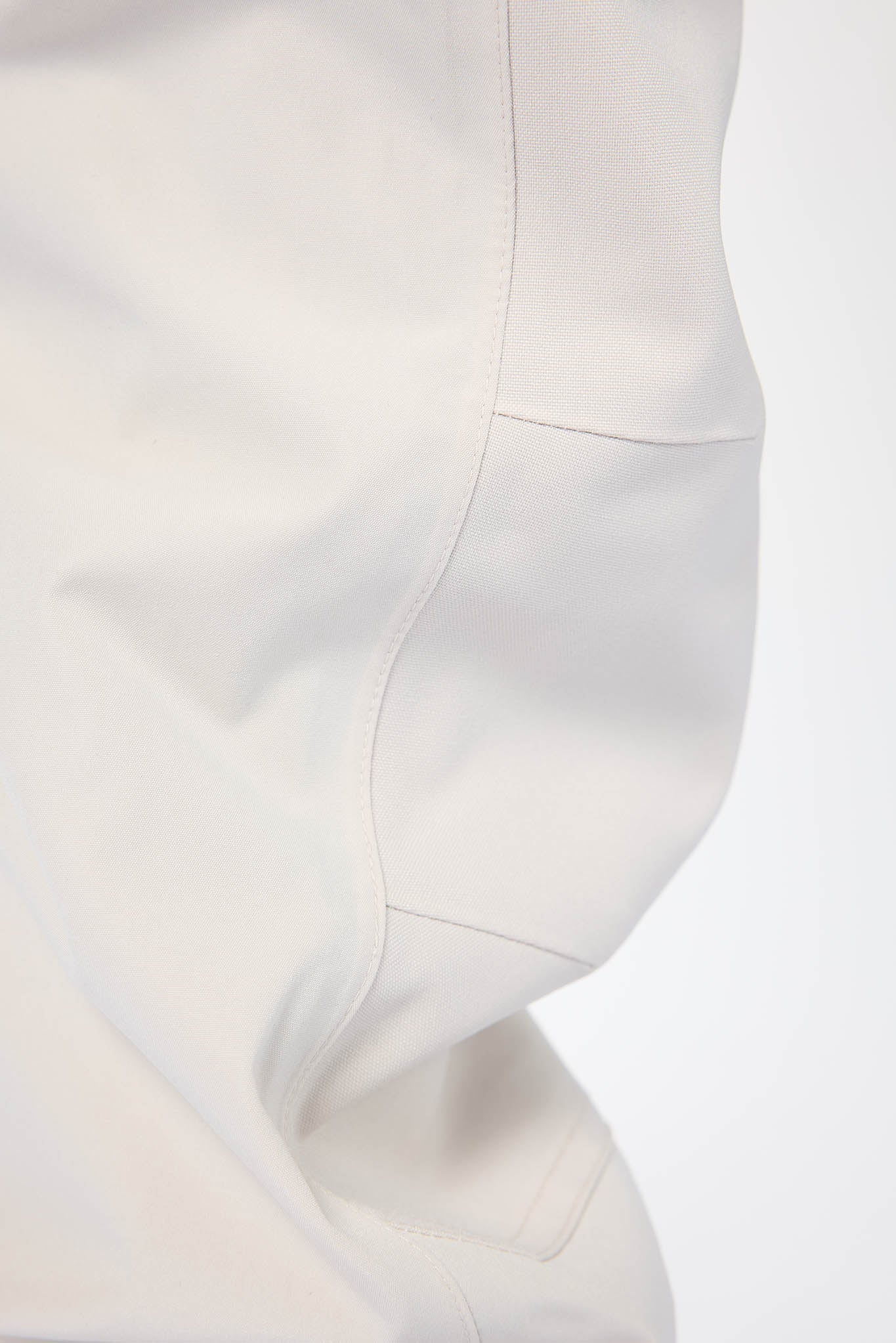 Close-up of a white garment on a light gray background