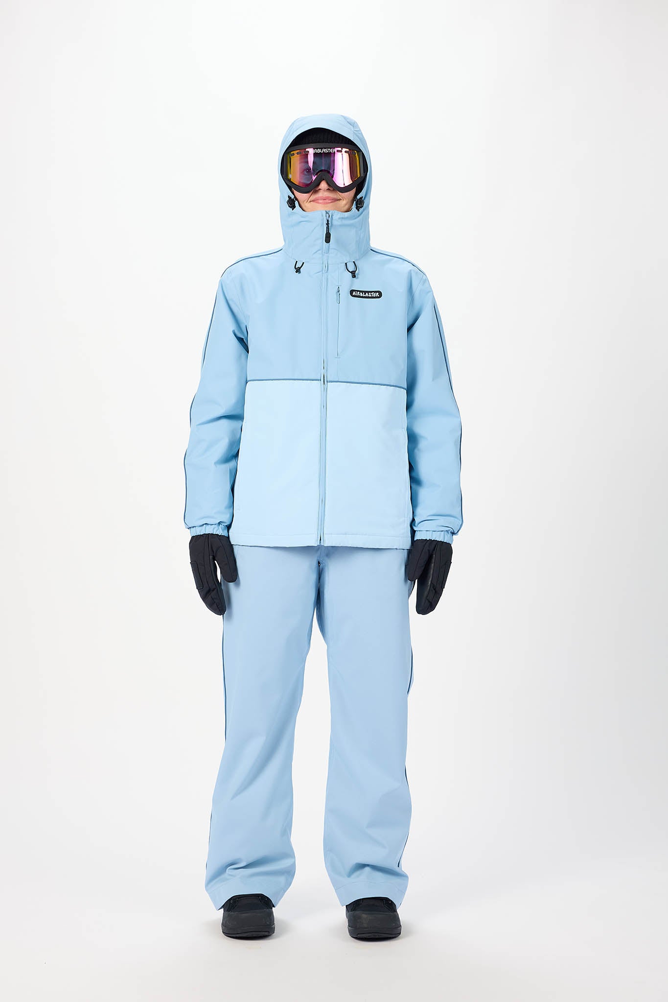 Person wearing a light blue snowsuit with goggles on a white background