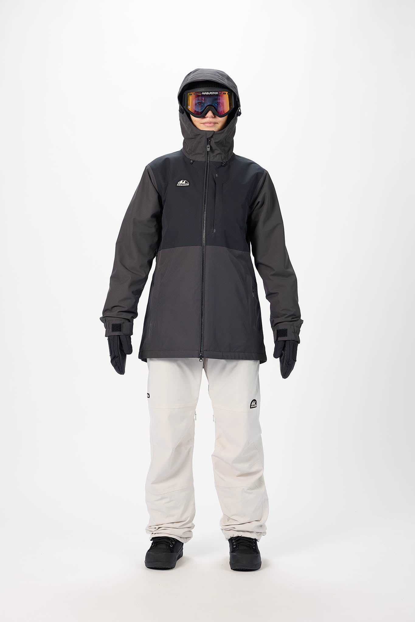 Person wearing a black snow jacket and pants with goggles on a white background