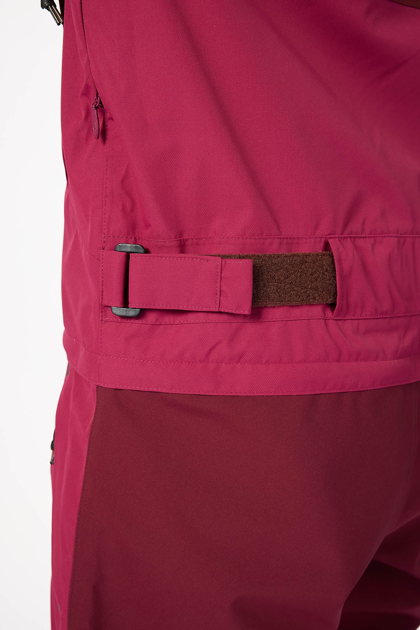 Close-up of a magenta jacket with a brown patch on a white background