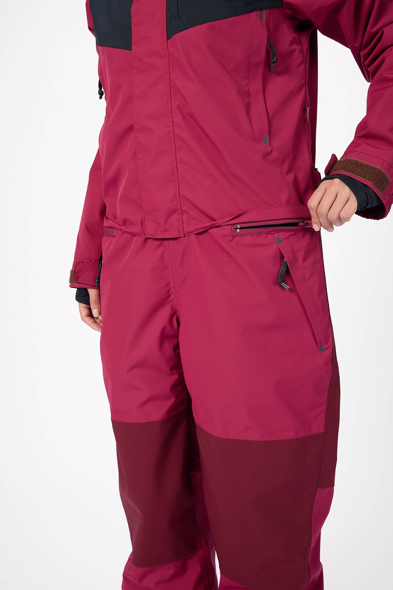 Maroon snowsuit with black accents on a white background